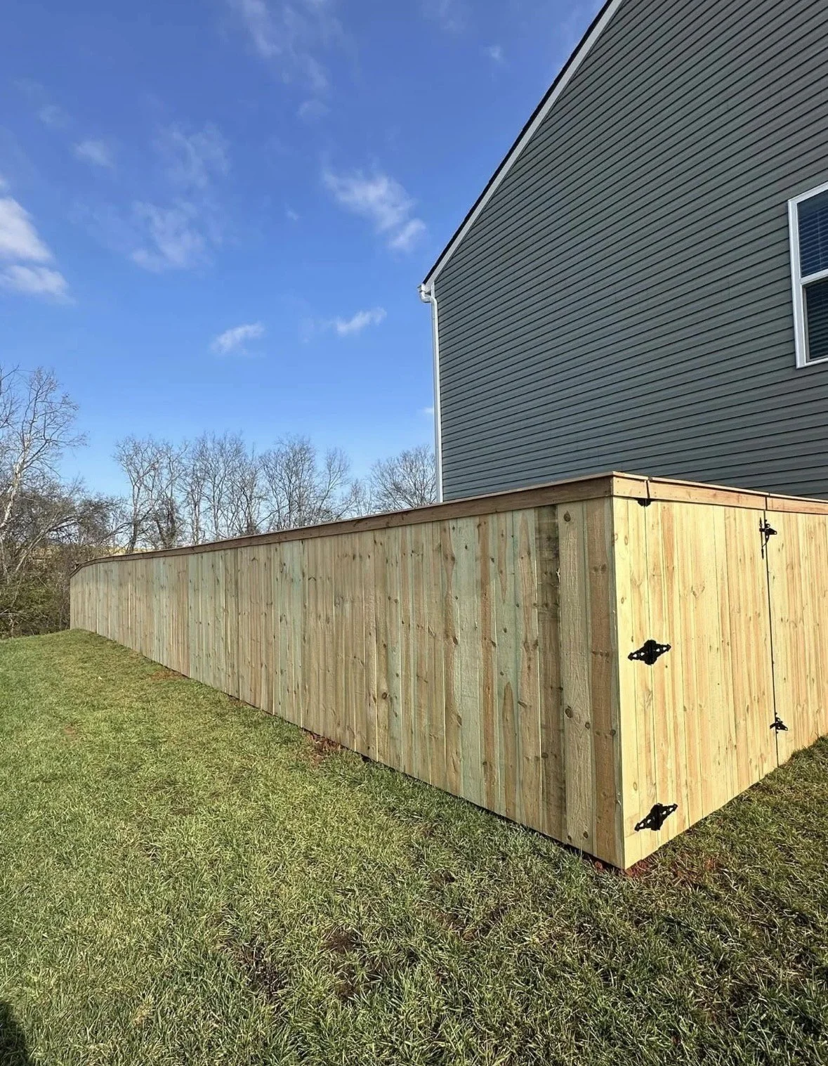Privacy fence installation offering both security and a clean, natural wood finish.
