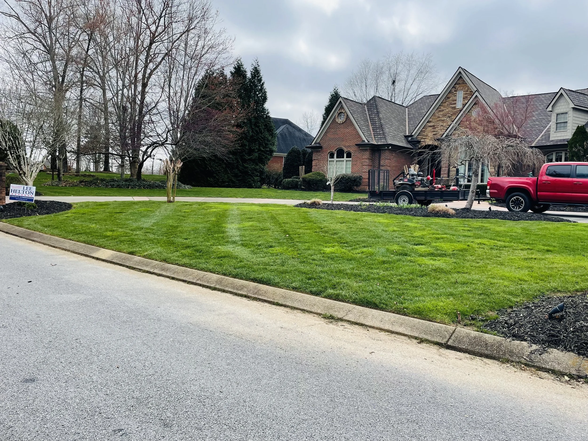 Perfectly edged, freshly cut grass along a residential sidewalk for a neat, polished neighborhood look.