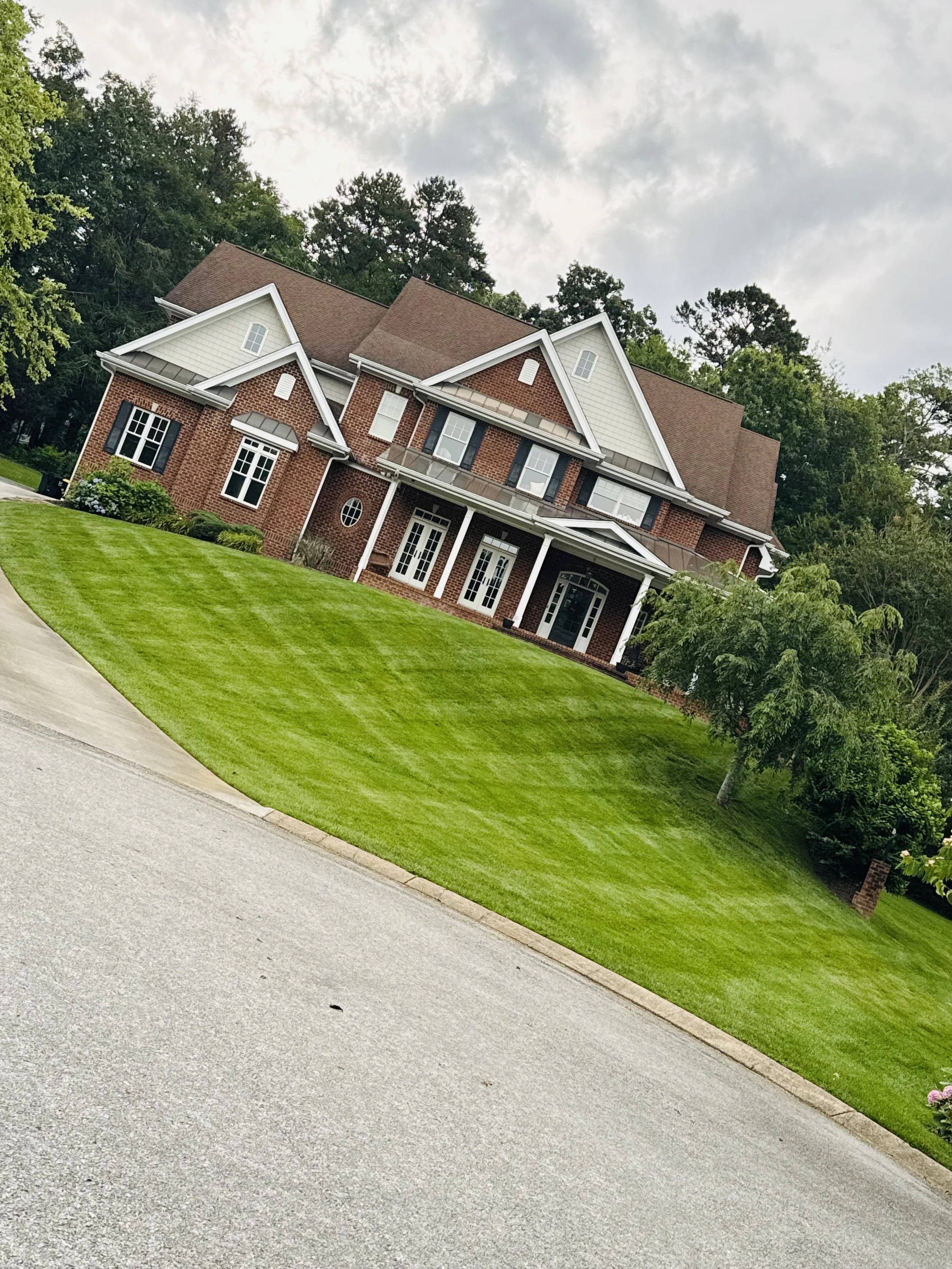 Professional lawn mowing with defined stripes showing precision care and healthy turf.