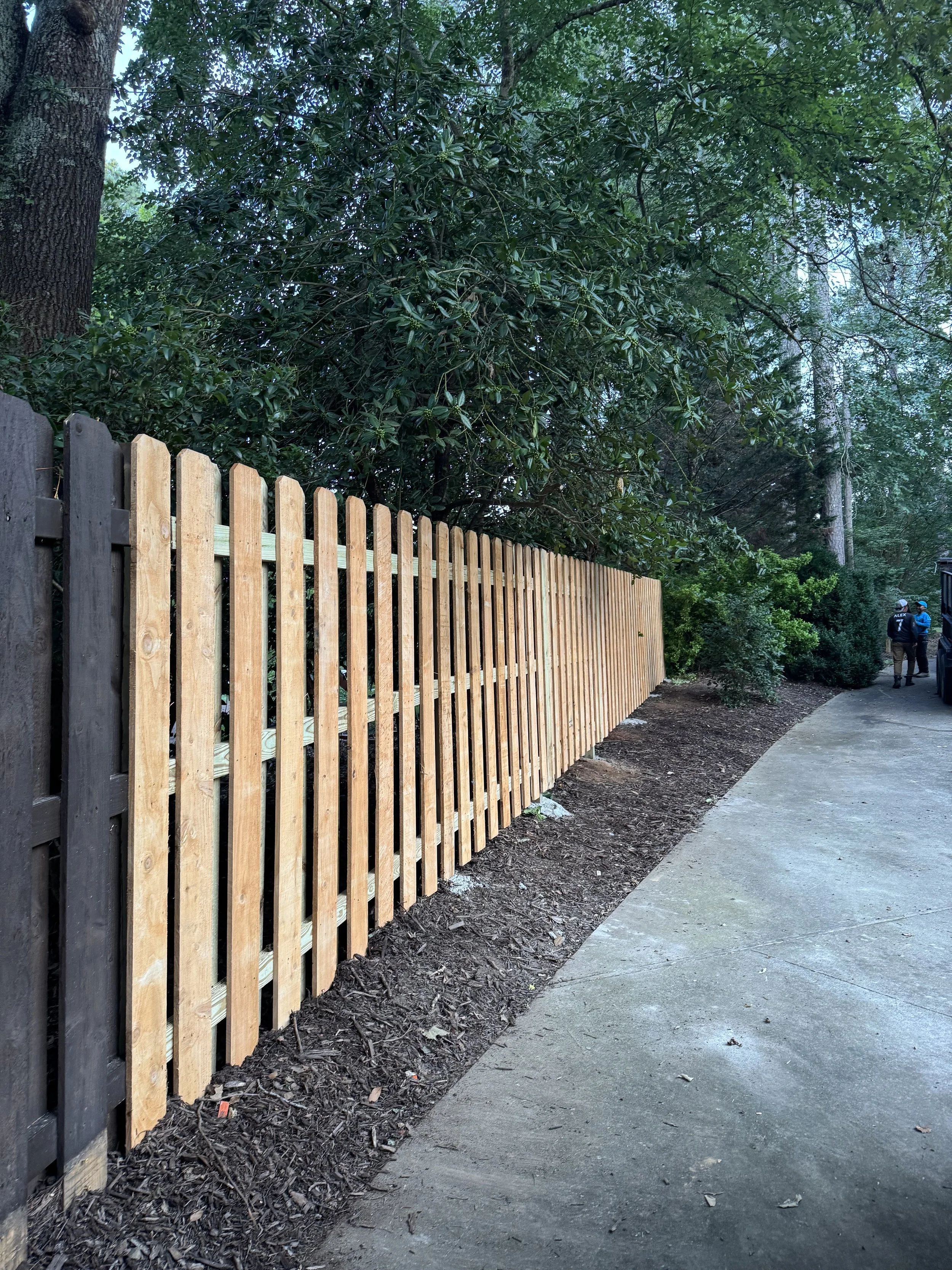 Fence installation and painting offering security, privacy, and increased curb appeal. 