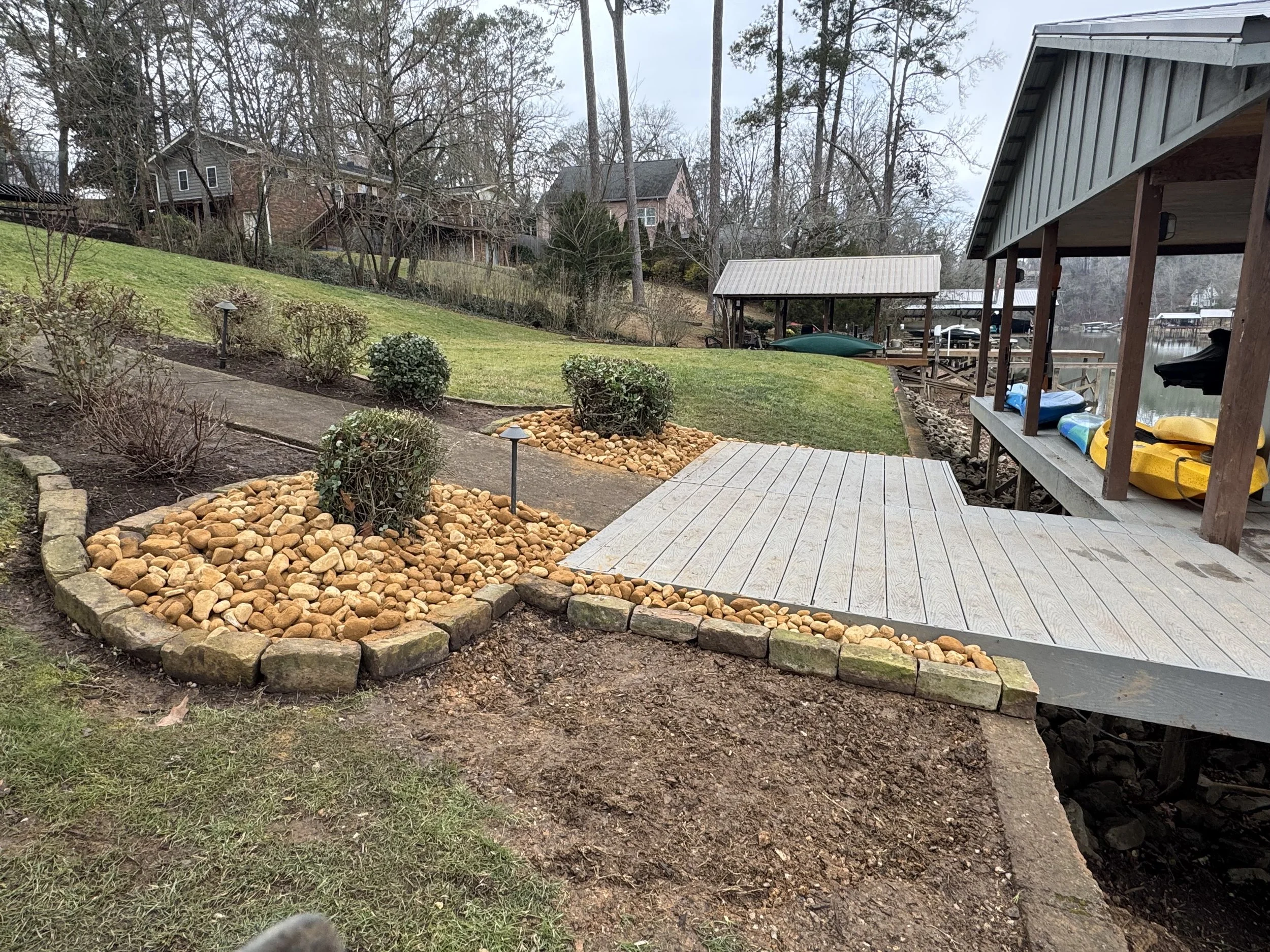 Backyard patio and stone garden beds designed for functionality and natural beauty.