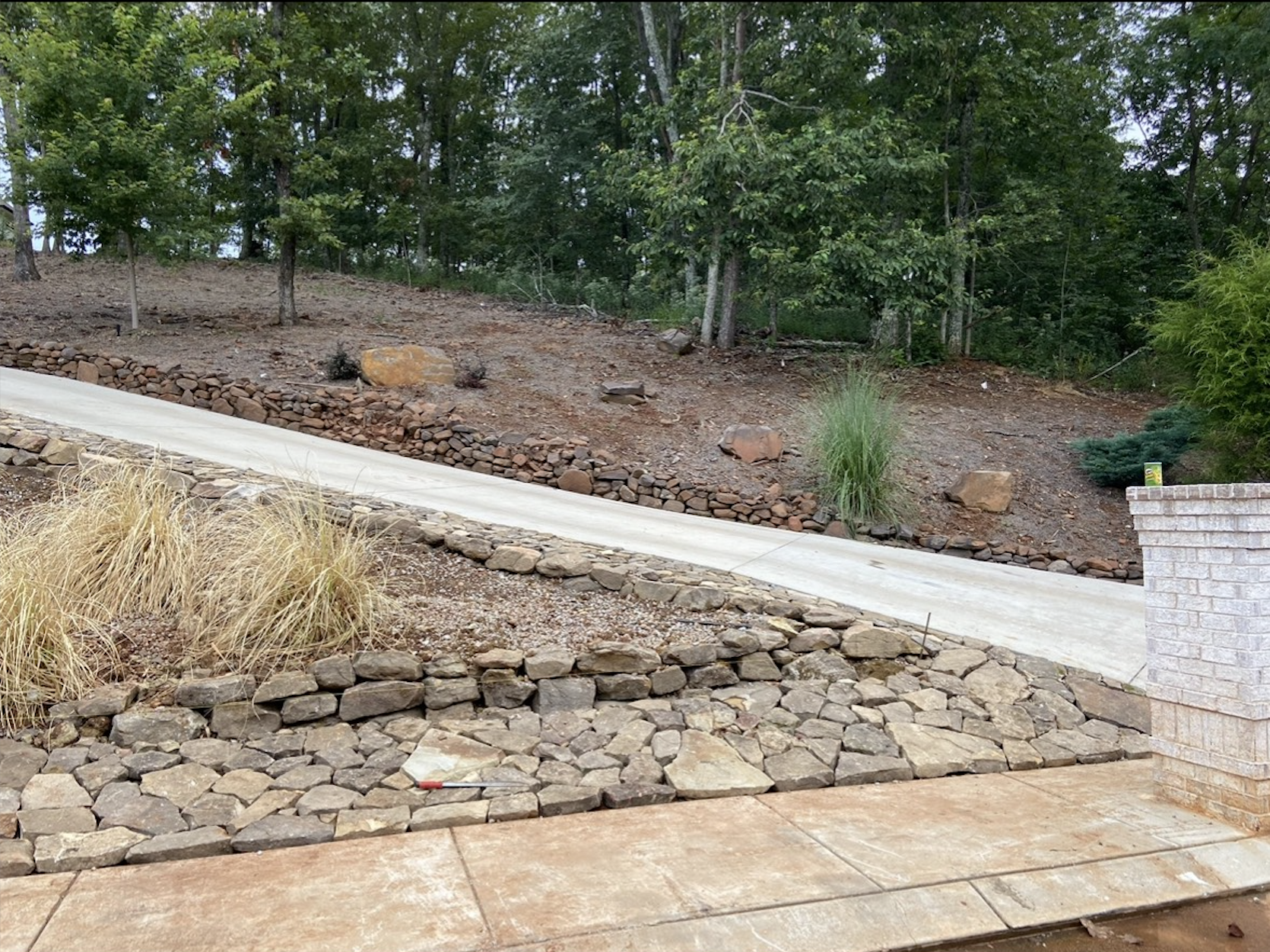 Newly finished driveway providing smooth access while blending naturally into the landscape.