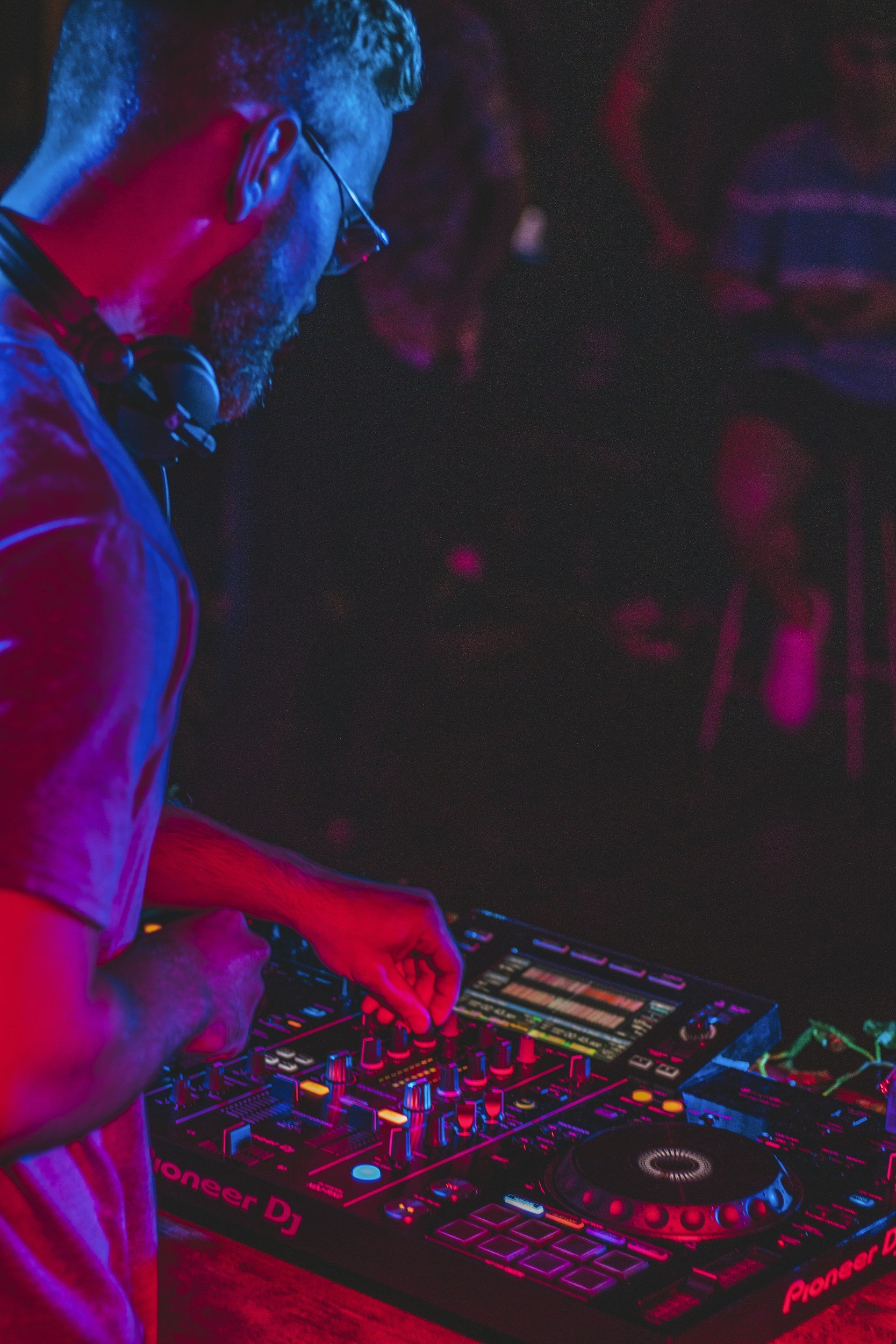 DJ performing under blue and red club lighting at CTRL Room, an entertainment-forward nightlife concept in Dallas
