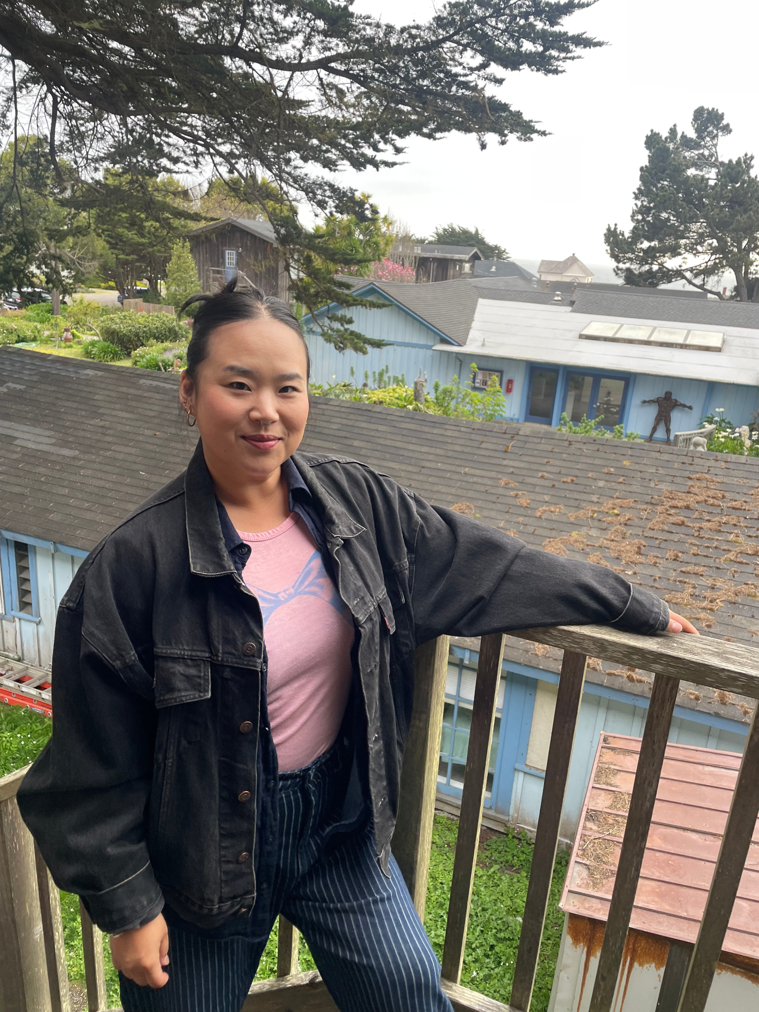 Mihee Kim standing in front of her home