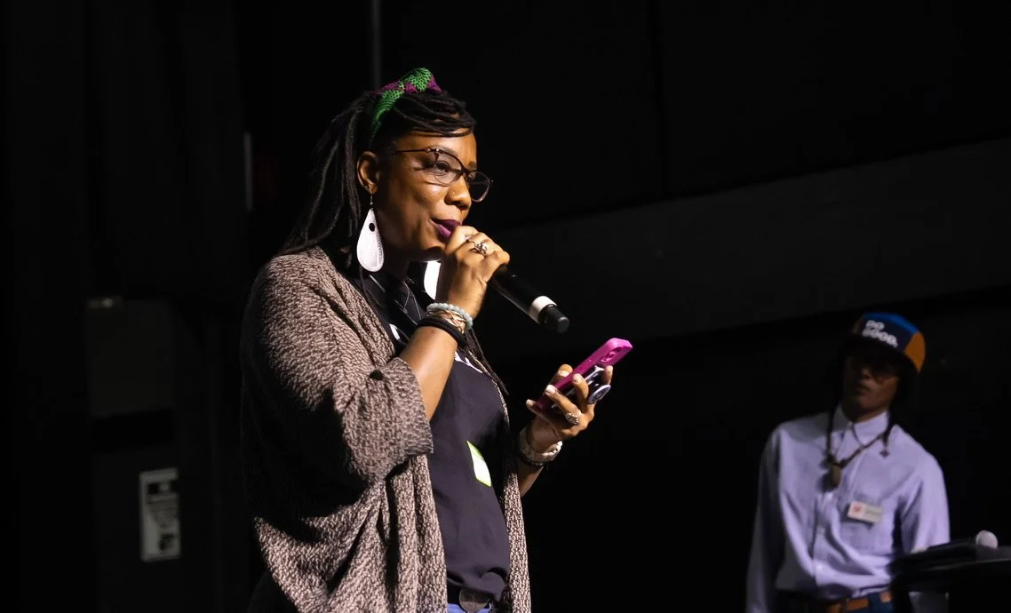 Woman speaking into a microphone