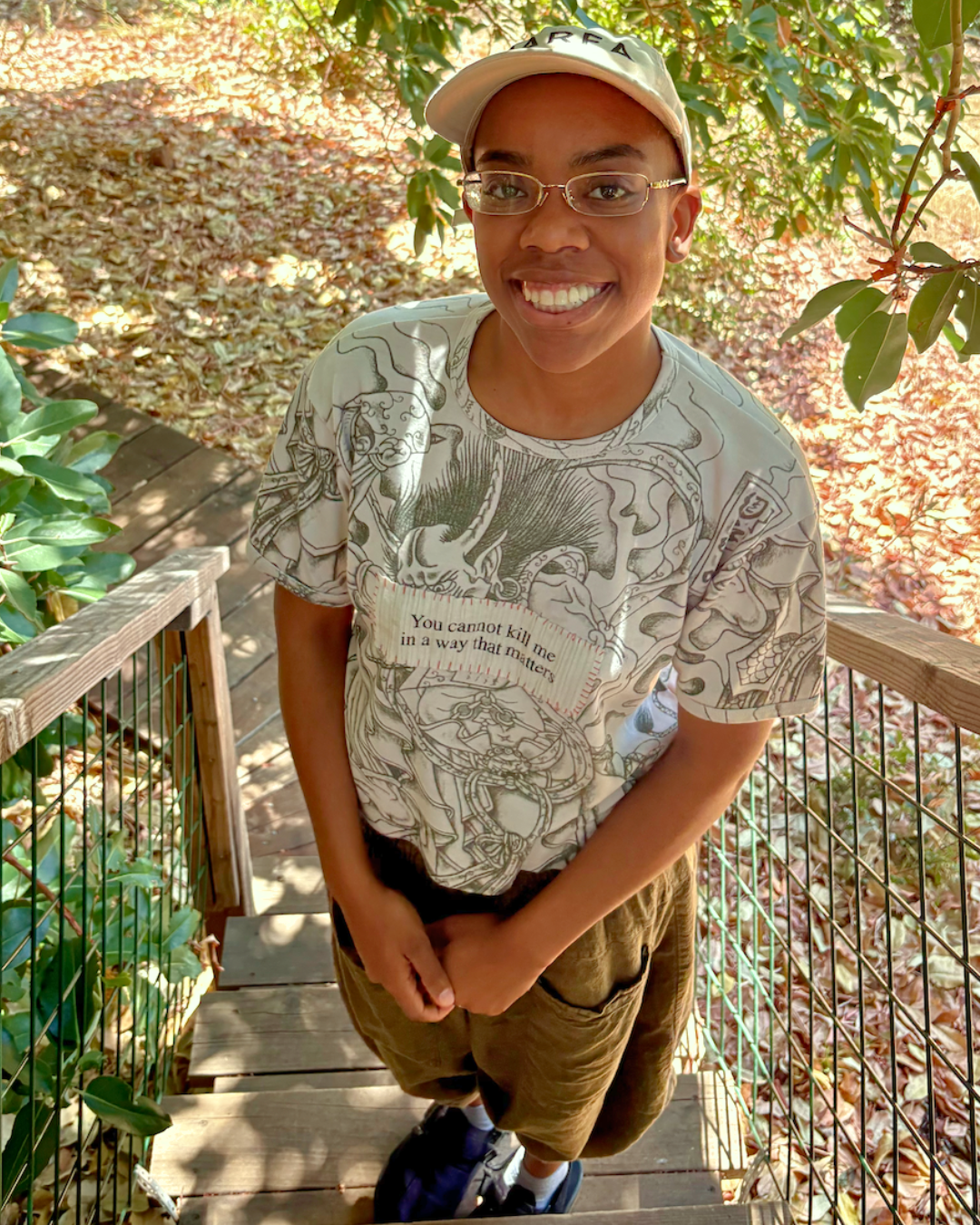 Jaelynn Walls stands on stairs outside, smiling at the camera