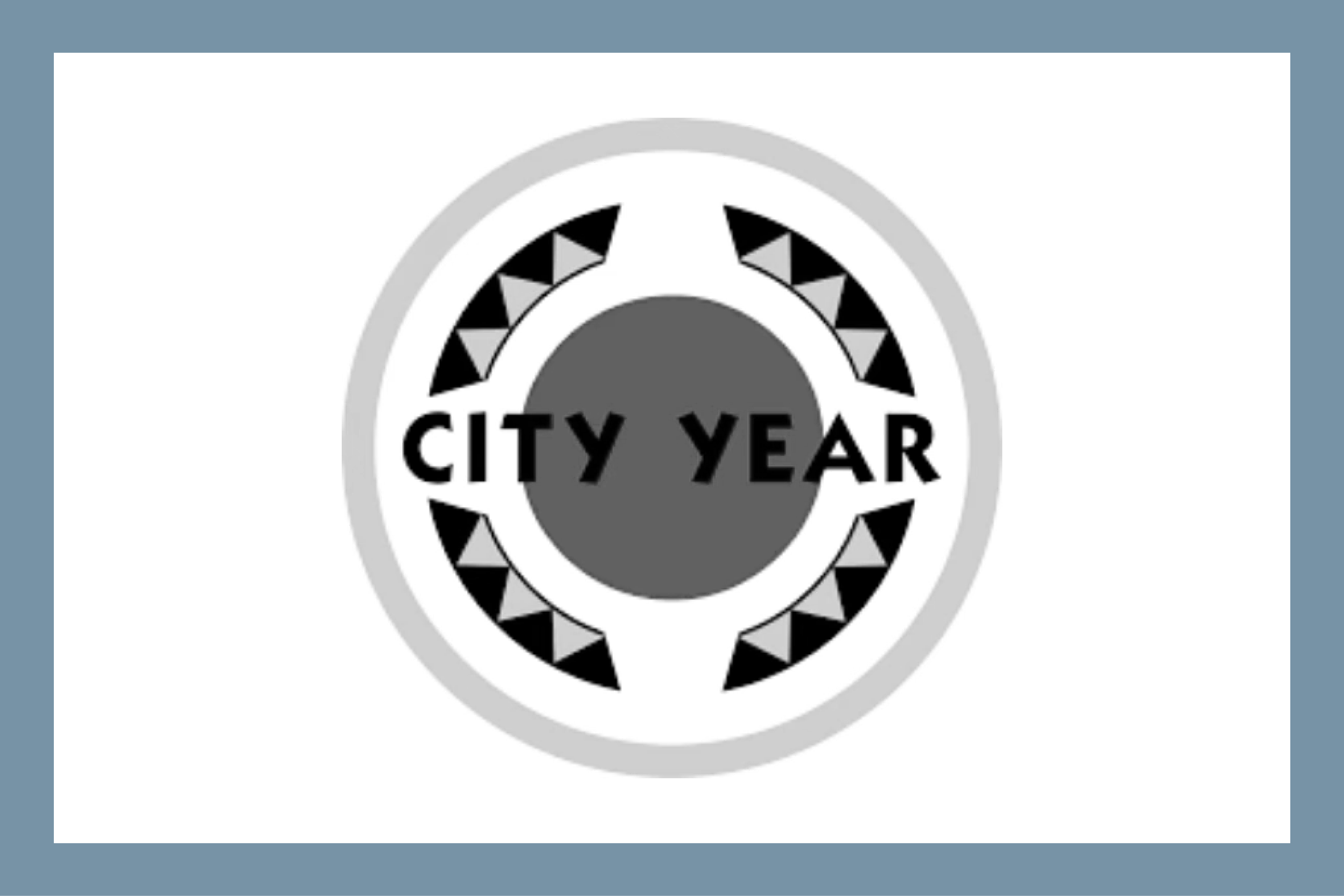 Logo with text 'CITY YEAR' inside a circle with triangular pattern border.