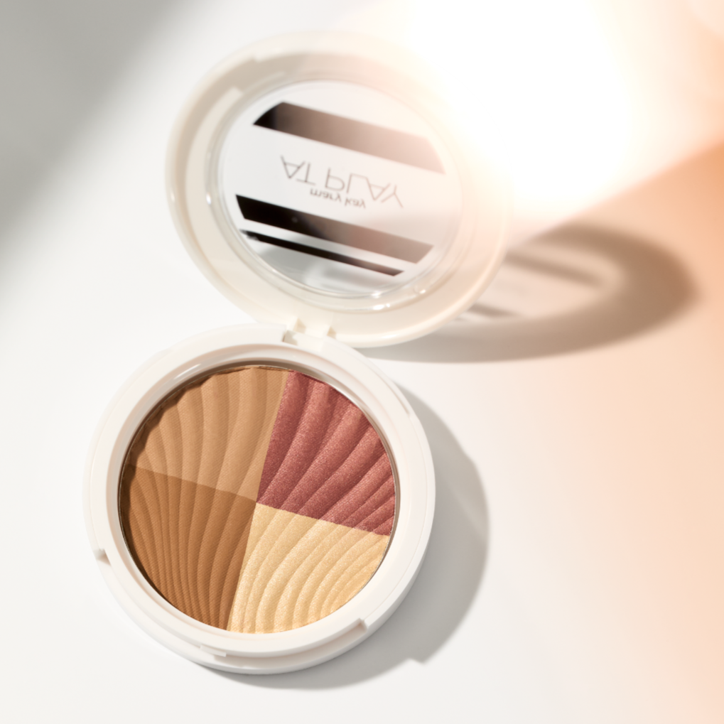 Open At Play compact by Mary Kay makeup with multicolored blush and bronzer on a white surface.