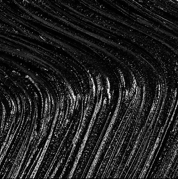 Close-up of dark, streaked marble or granite surface with white veining.