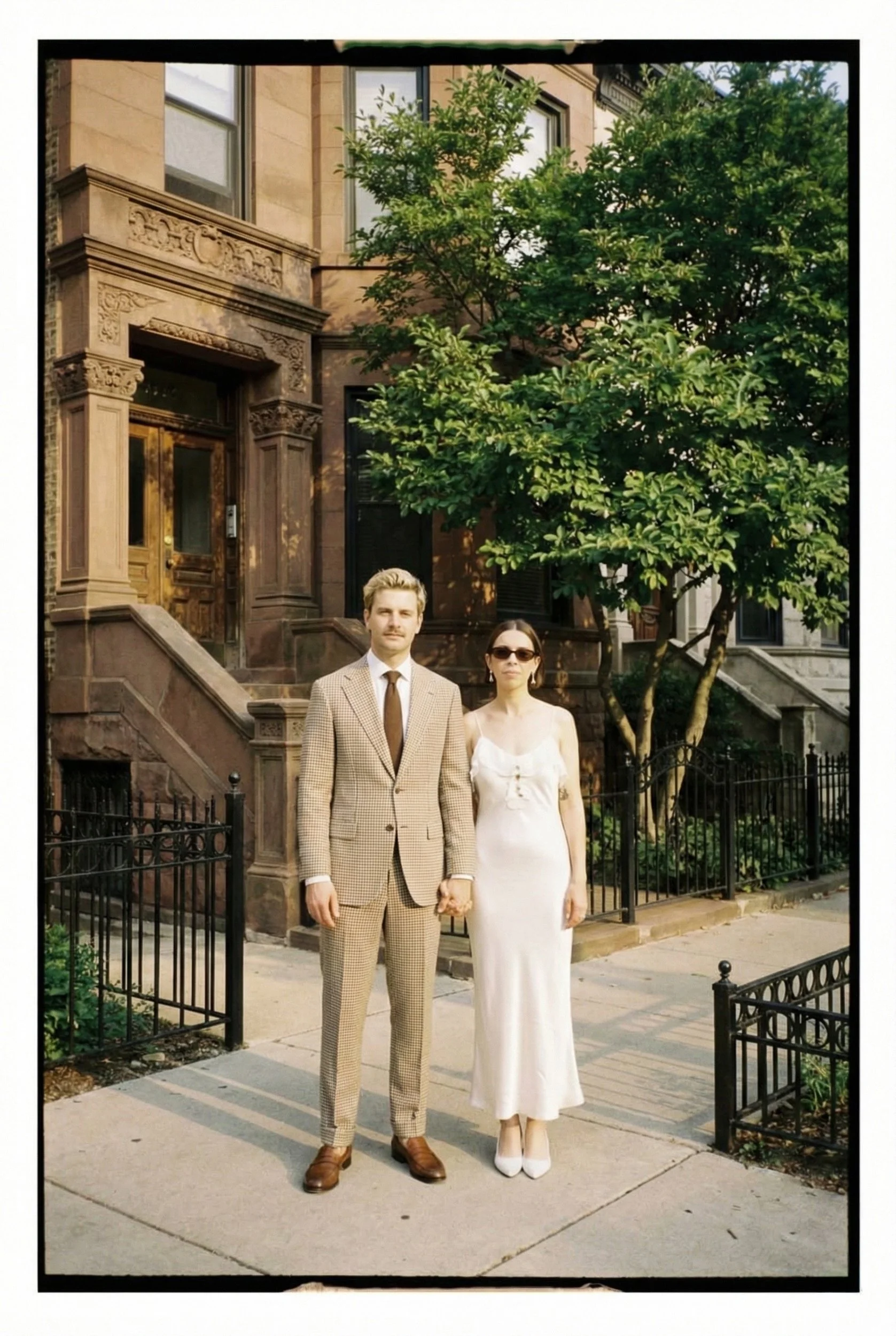 modern chicago gen z couple on their wedding day in front of lincoln park brownstone homes in chicago