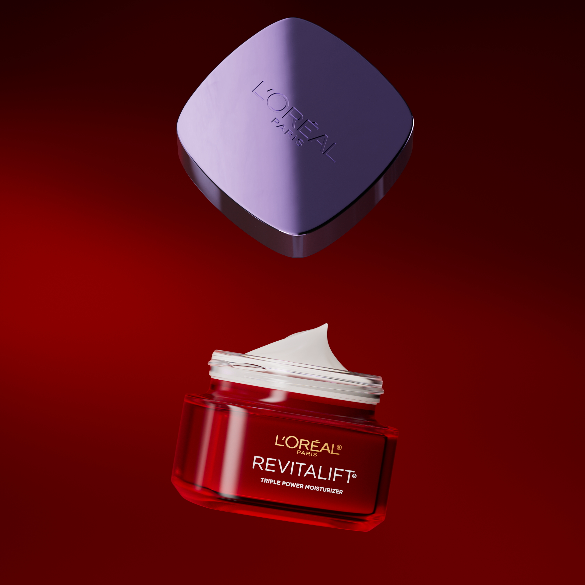 A jar of L'Oréal Paris Revitalift Triple Power Moisturizer with its lid floating above it against a red background.
