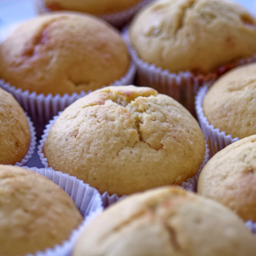Close-up of golden-brown muffins in paper liners.