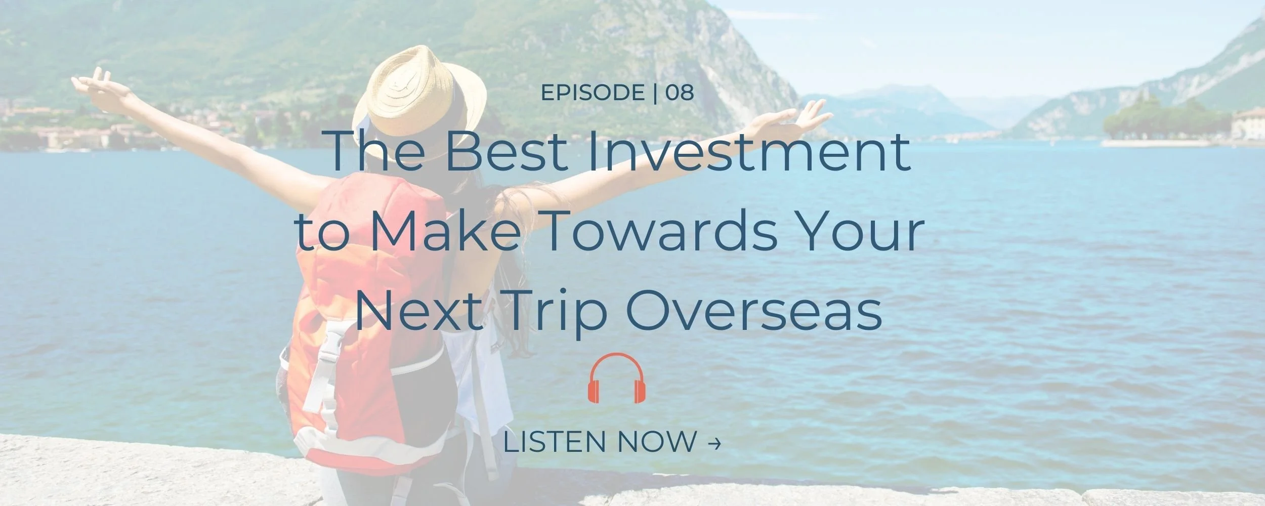 Girl with backpack sitting on edge of a bay with mountains surrounding her.