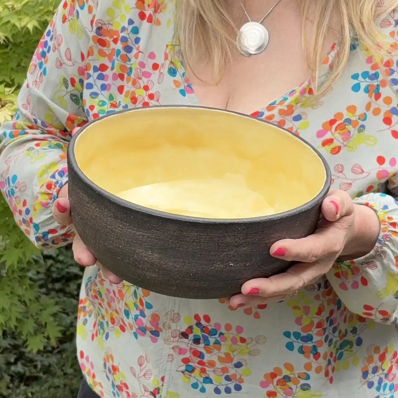 Stoneware bowl with glossy glazed yellow interior
