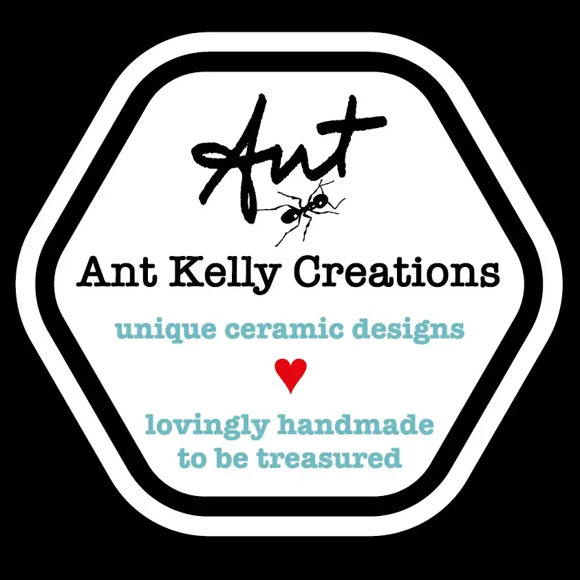 Logo for Ant Kelly Creations with black text, a small red heart, and an ant graphic in a hexagonal shape