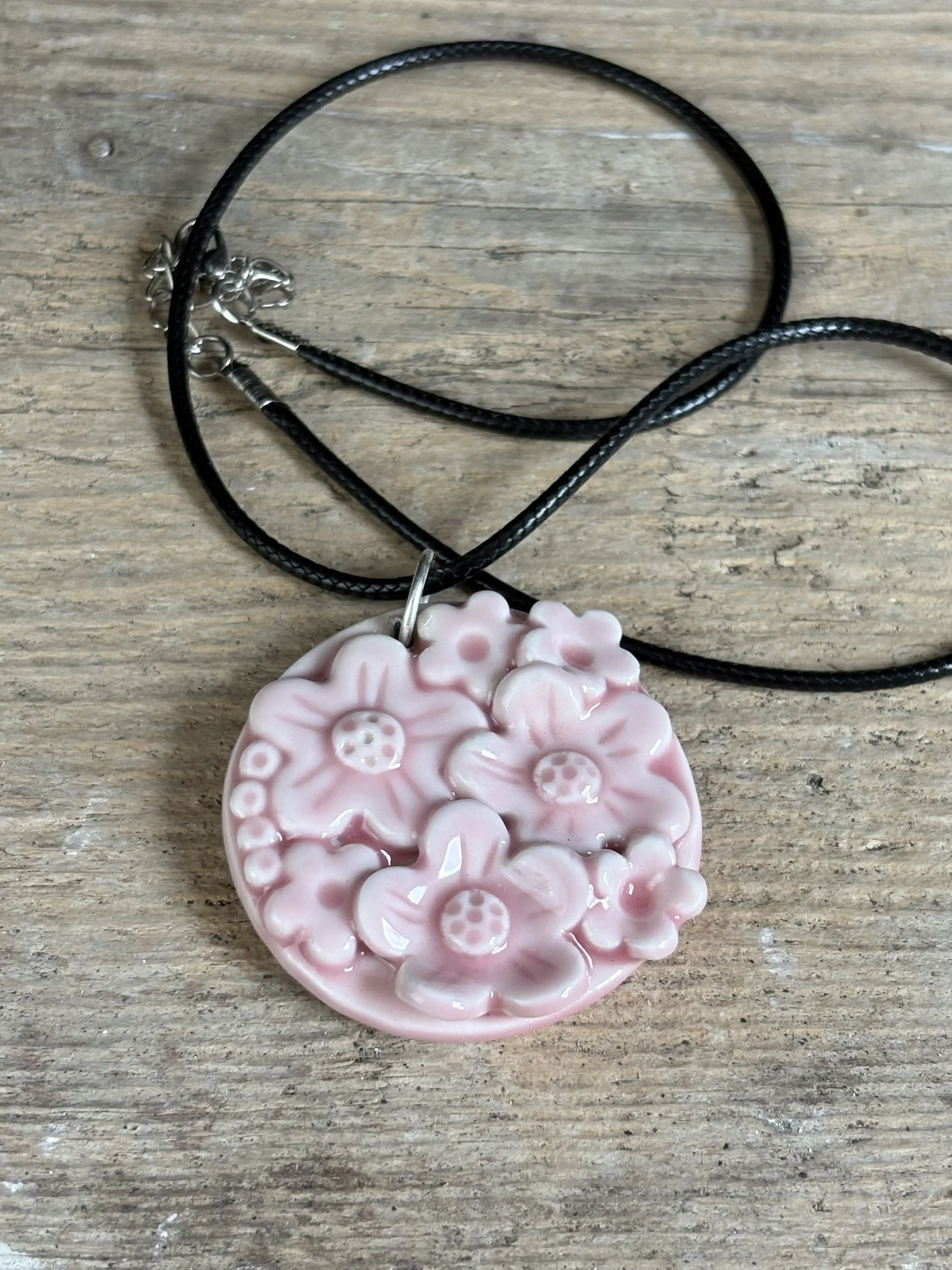 pink pendant on wooden bkgrnd.webp