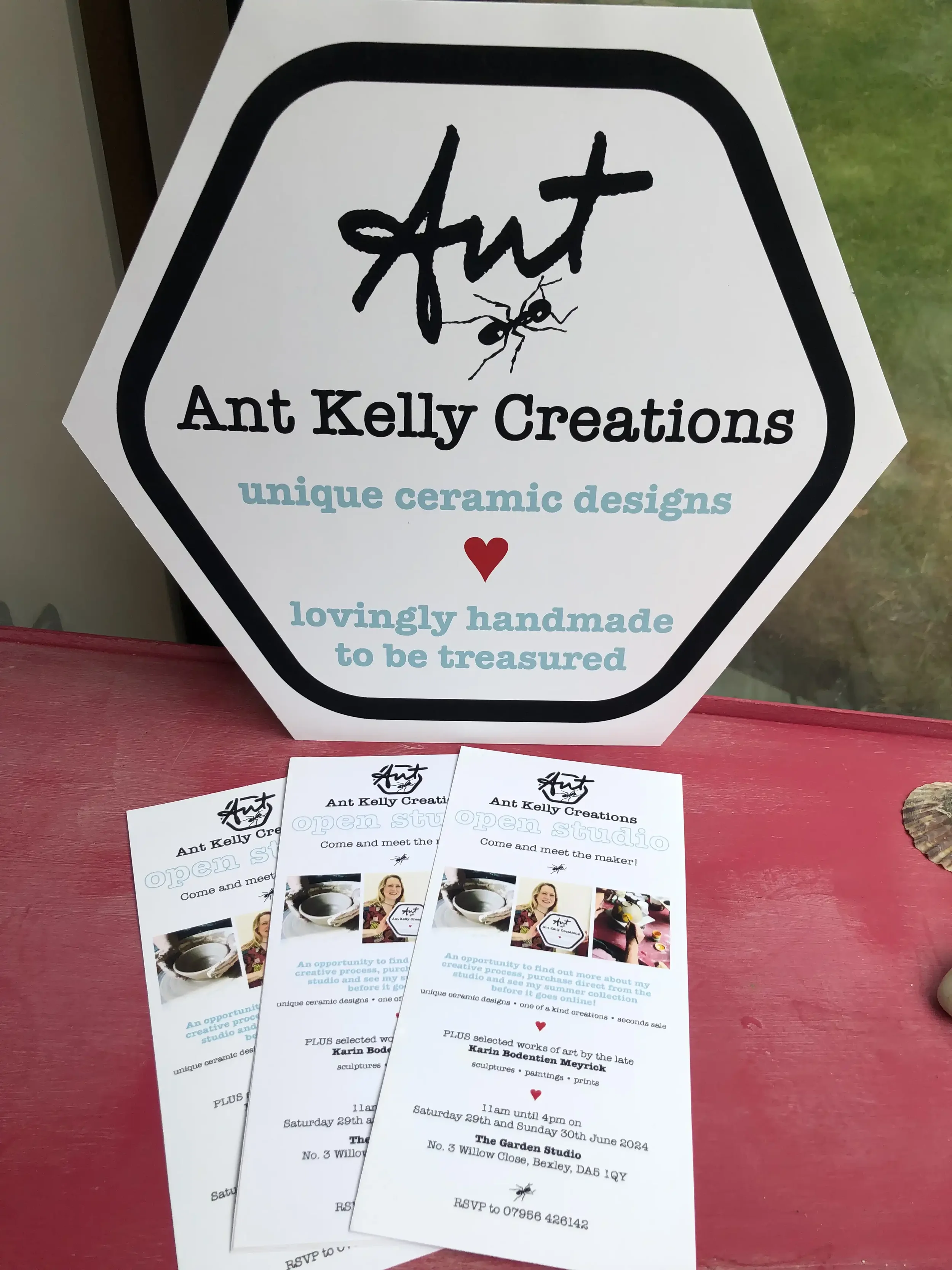 Sign for Ant Kelly Creations with an ant illustration, stating 'unique ceramic designs' and 'lovingly handmade to be treasured'. Brochures for the studio showing images of ceramic art and event details.