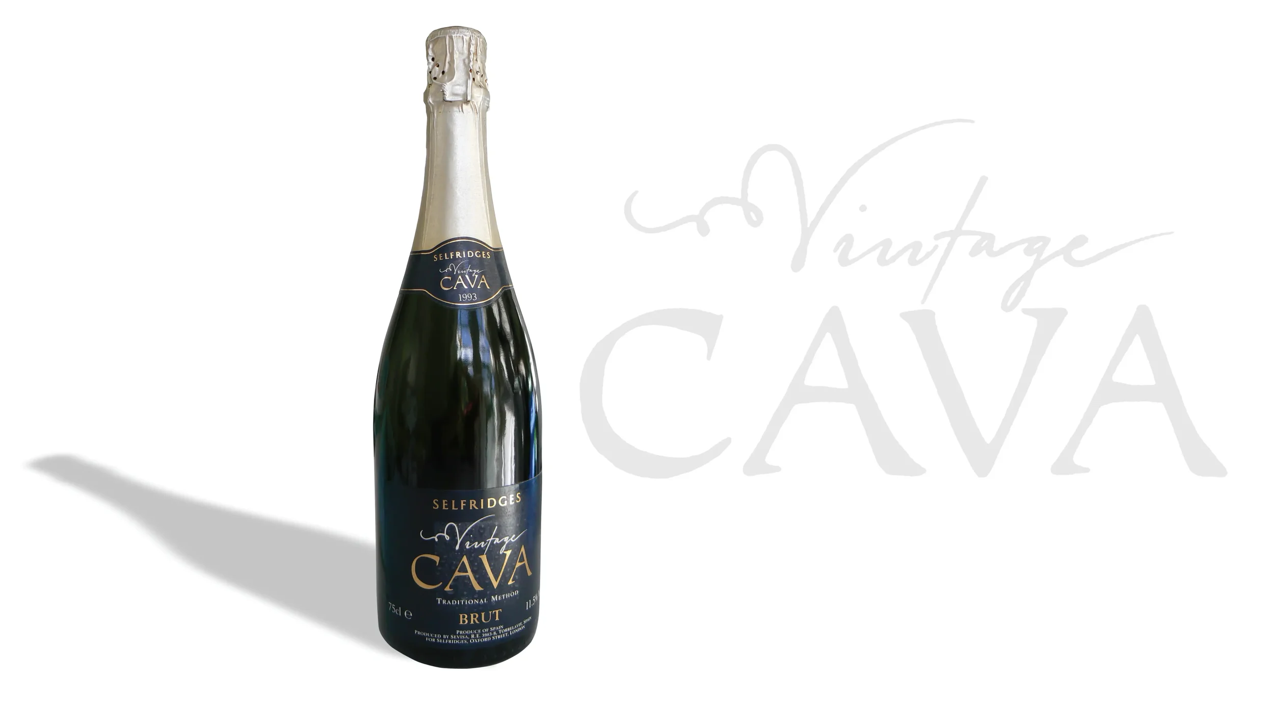A bottle of Selfridges vintage cava brut champagne with a black label and silver foil at the top, casting a shadow on a white background with a faint 'Vintage CAVA' script.