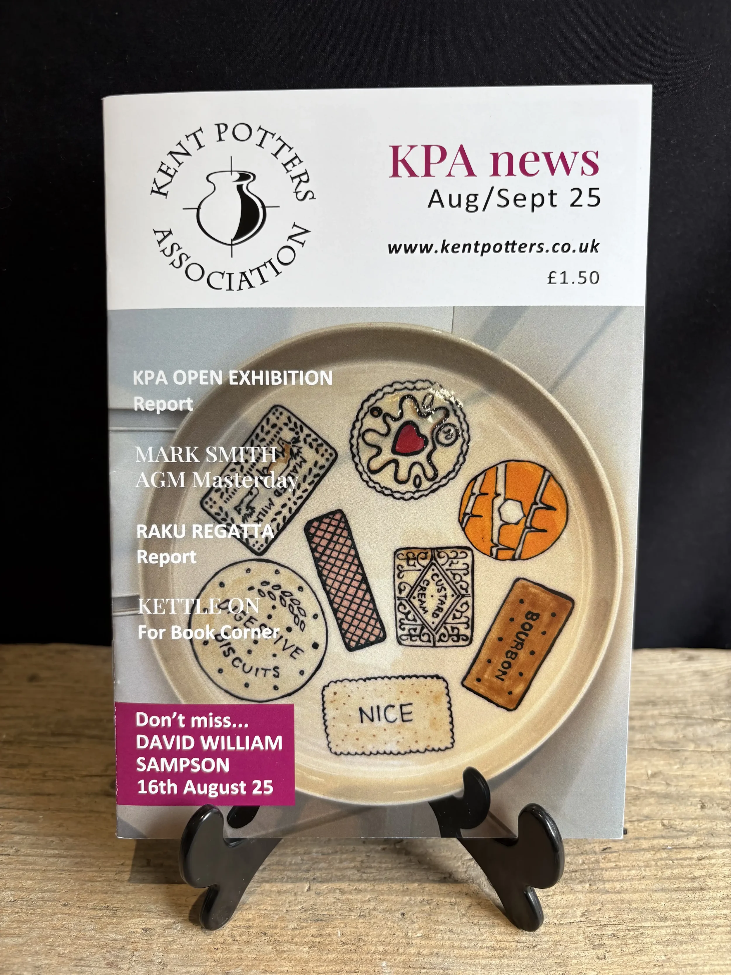 Kent Potters Association newsletter. Title 'KPA news Aug/Sept 25'  and Kent Potters website link. Front cover features ceramic 'biscuit selection' plate with some popular British biscuits designed by Ant Kelly Creations.