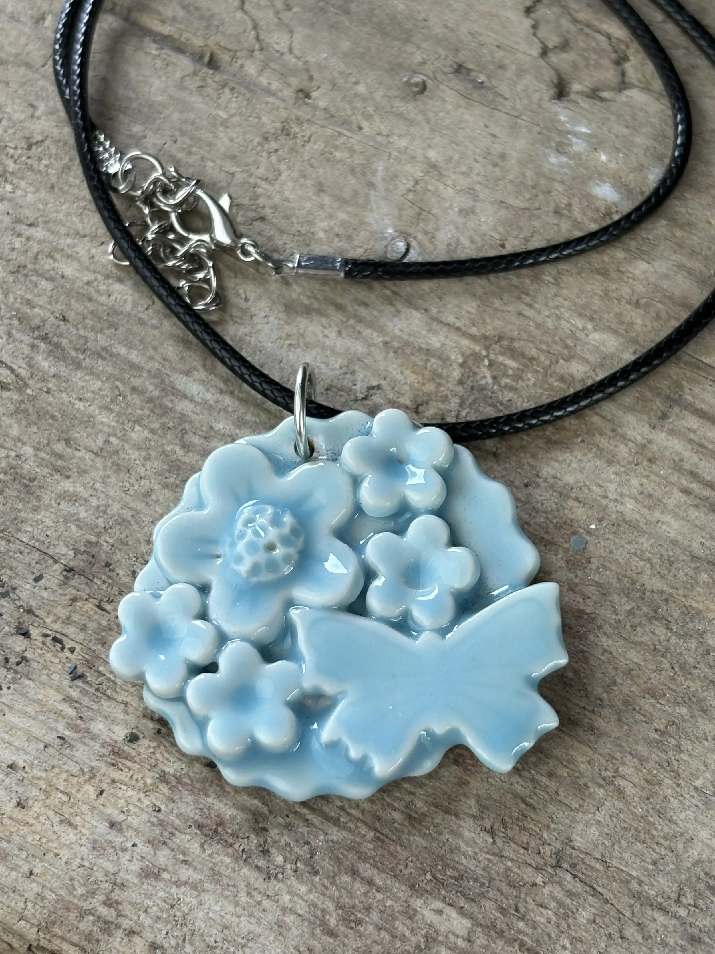blue pendant on wooden bkgrnd.webp