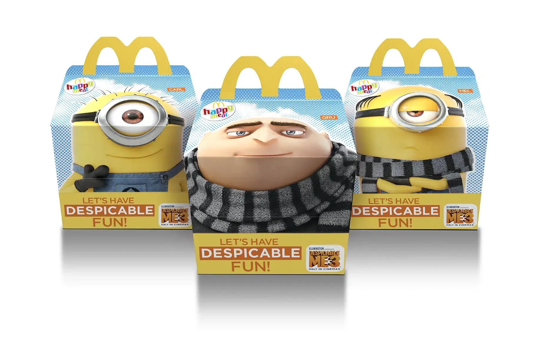 Three Minions-themed McDonald's Happy Meal boxes featuring characters from Despicable Me 3, with one box showing a Minion with a single eye and the other a Minion with one eye closed, and Gru's face in the middle.