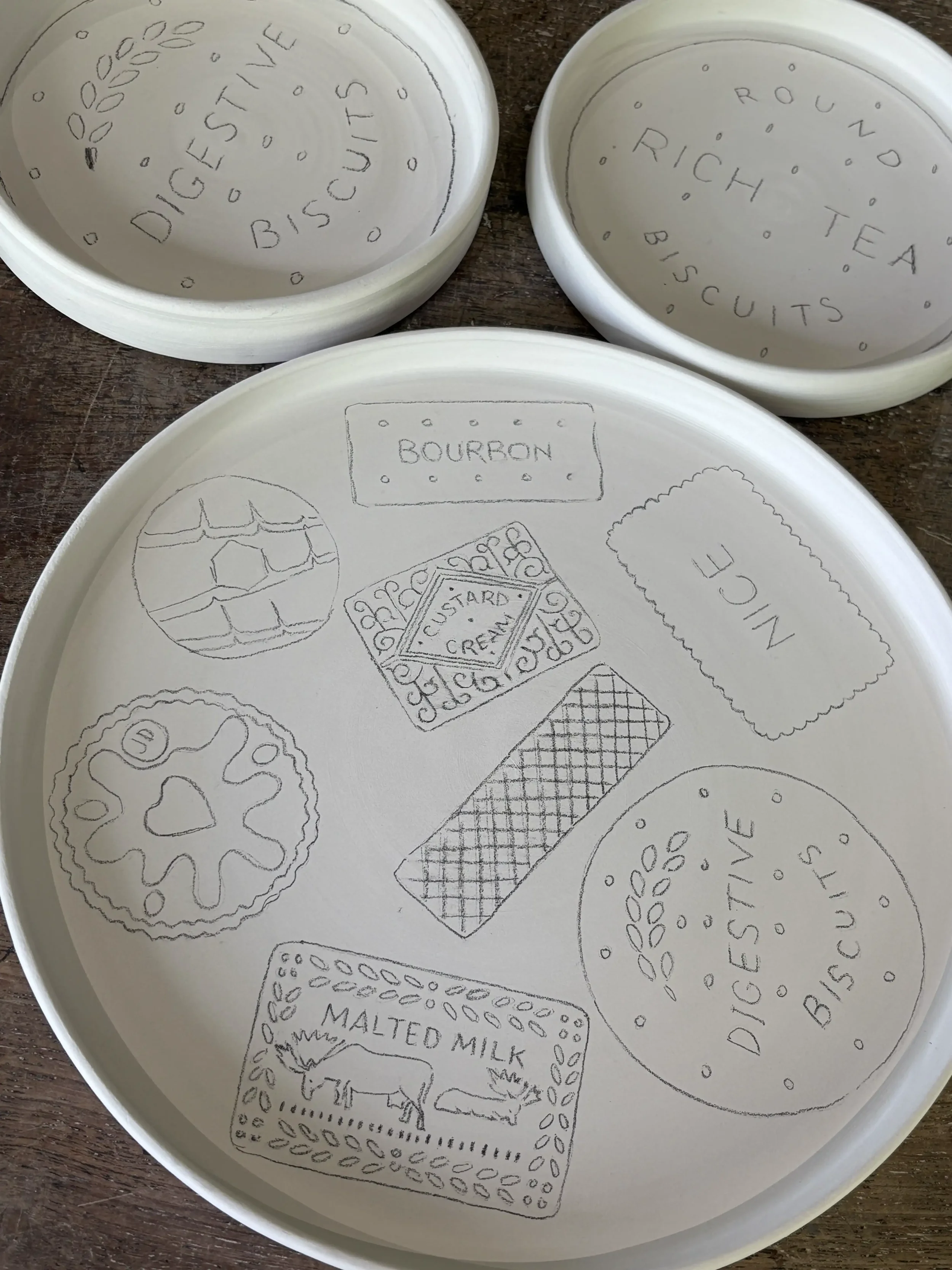 Pencil sketches on bisque fired plates.