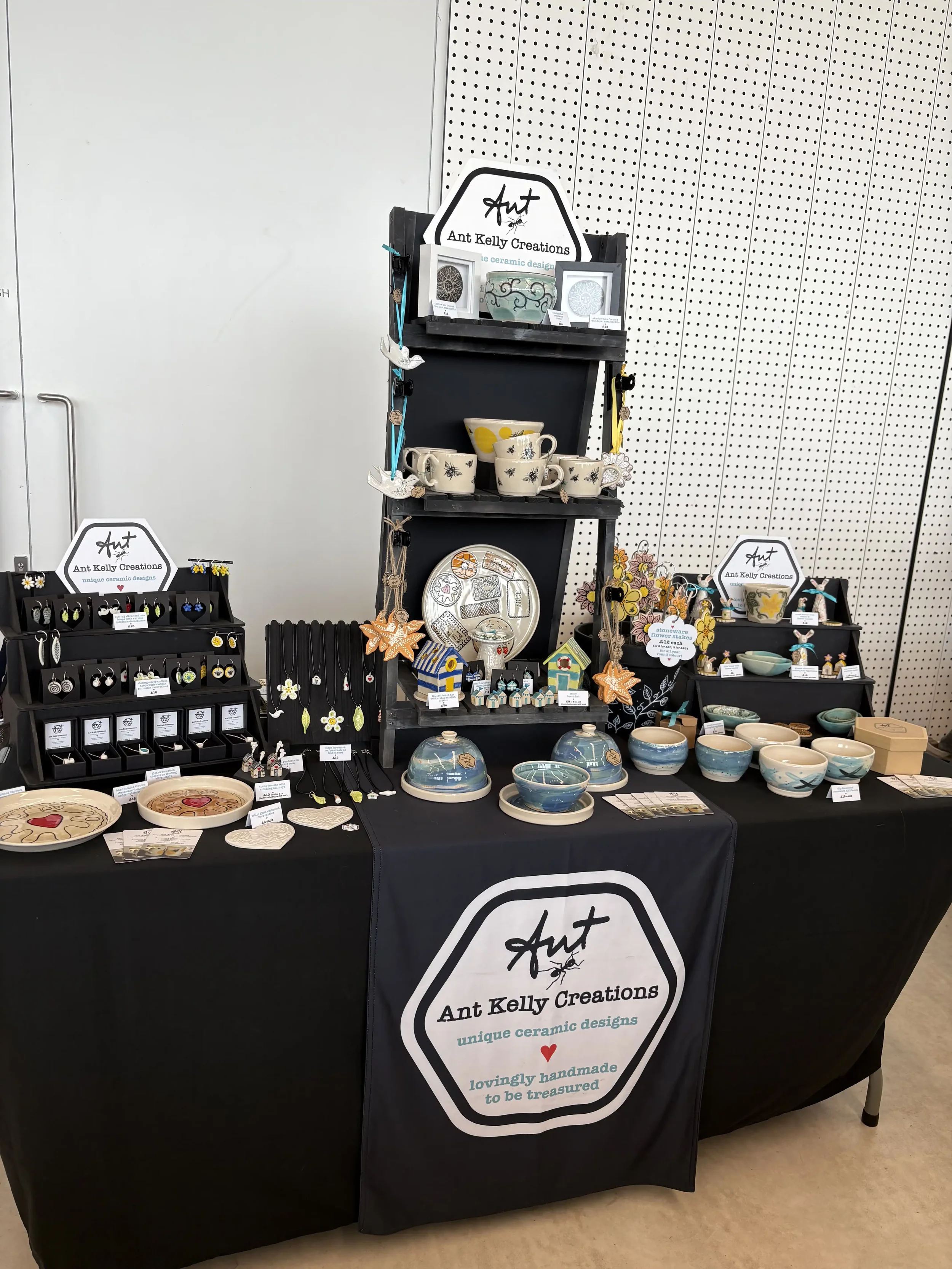 Display table showcasing handcrafted ceramics by Ant Kelly Creations.