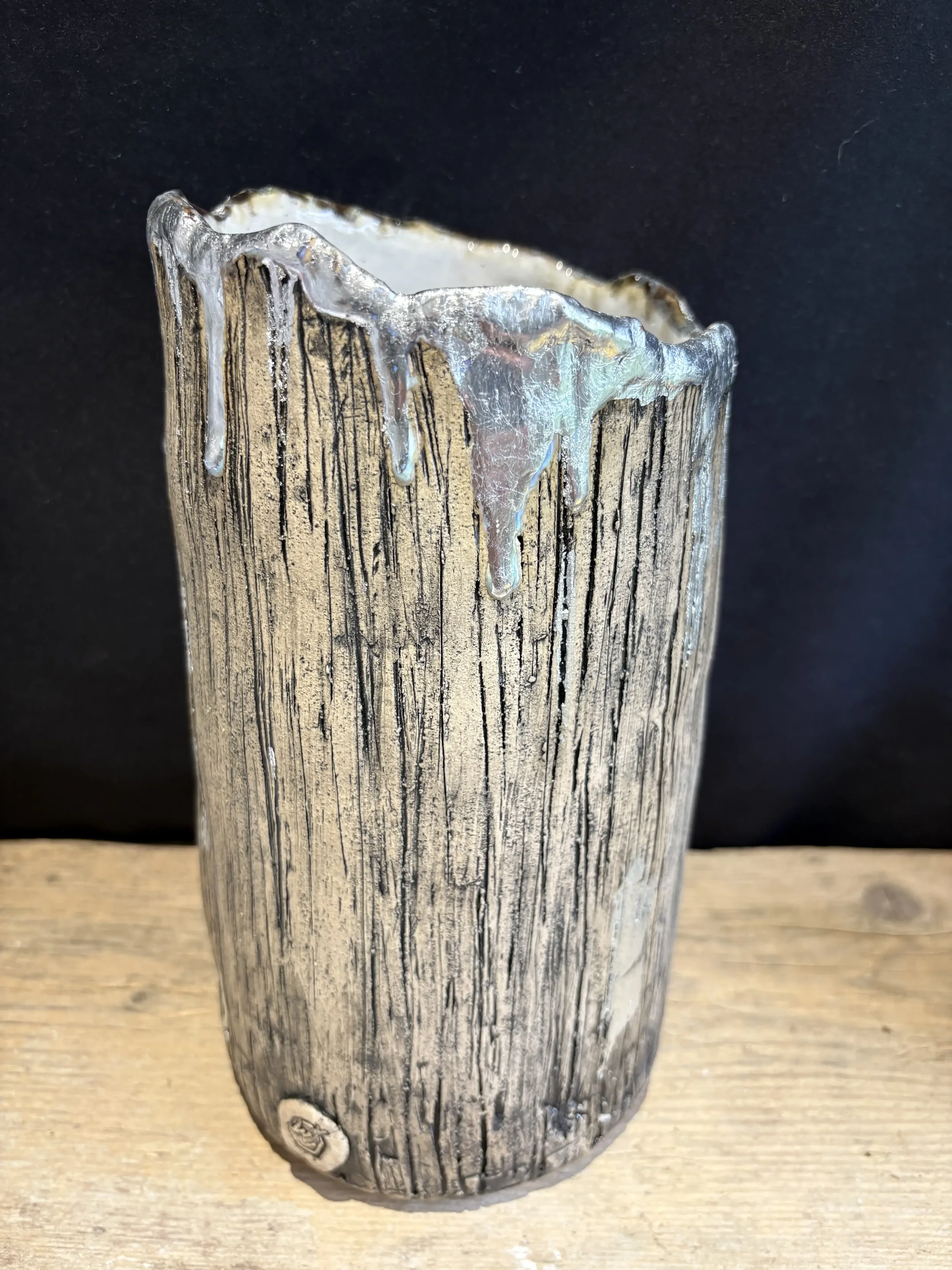 Large 'trunk' vase with texture to resemble bark and a 'frosted' silver leaf finish.