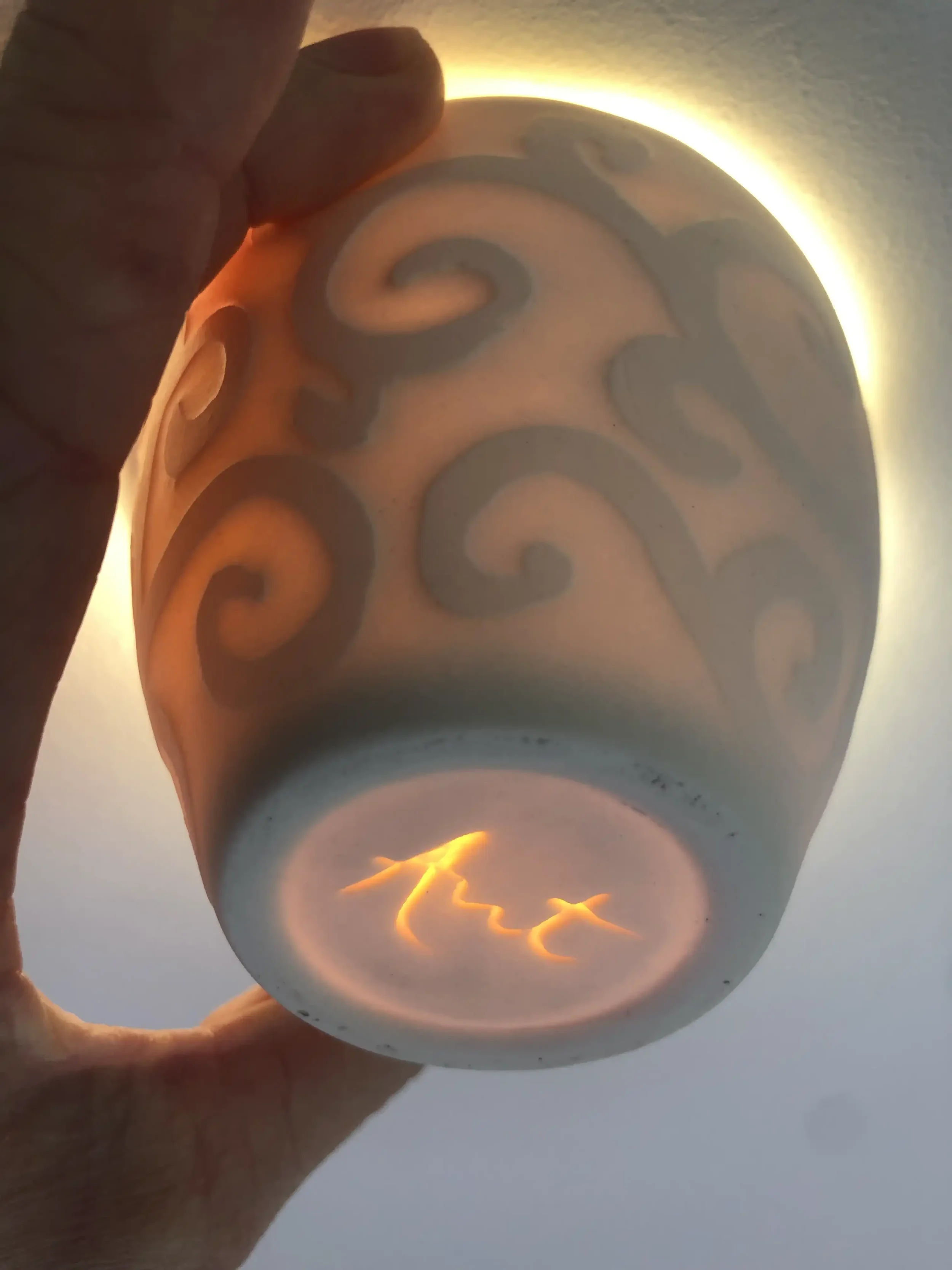 Translucency of water-etched slip-cast cup pattern.