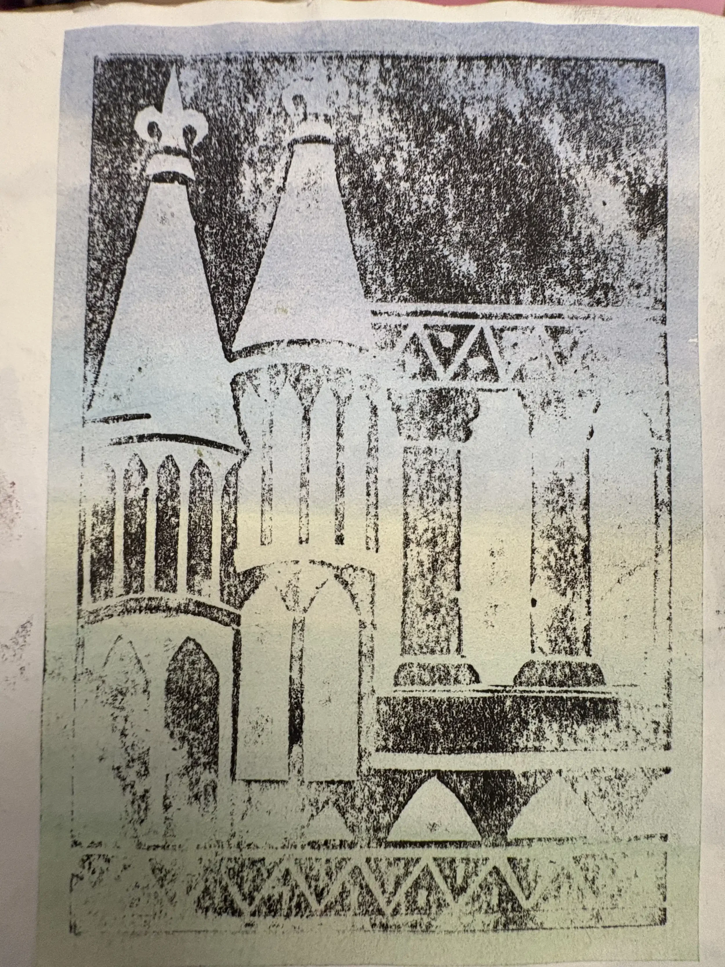 A black and white lino print of a medieval castle with towers, arches, and a bridge.