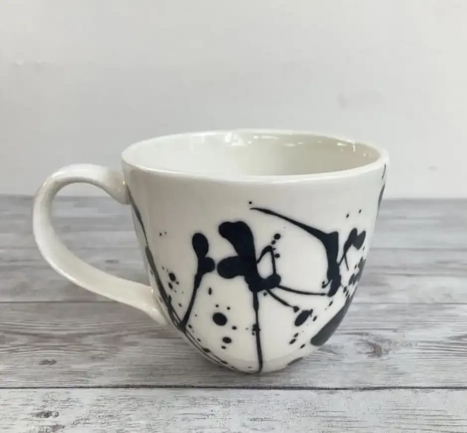 Splatter design slip-cast cup with handle - photograph with thanks to Sophie Southgate.