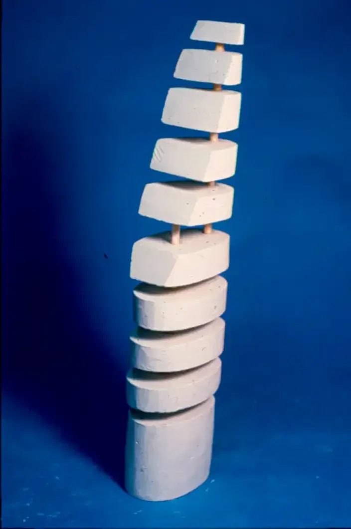 Sculpture construction made in tapering sections made from plaster and dowels.