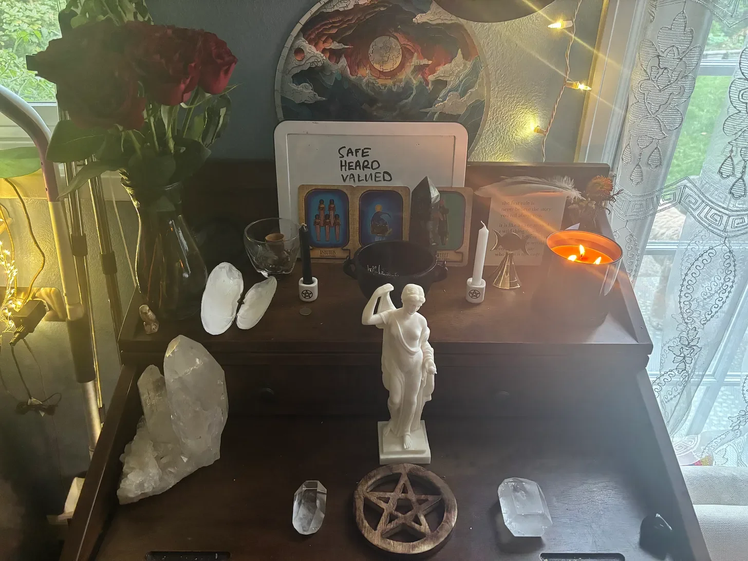 Picture of my altar with my Eris statue, candles, and may cauldron