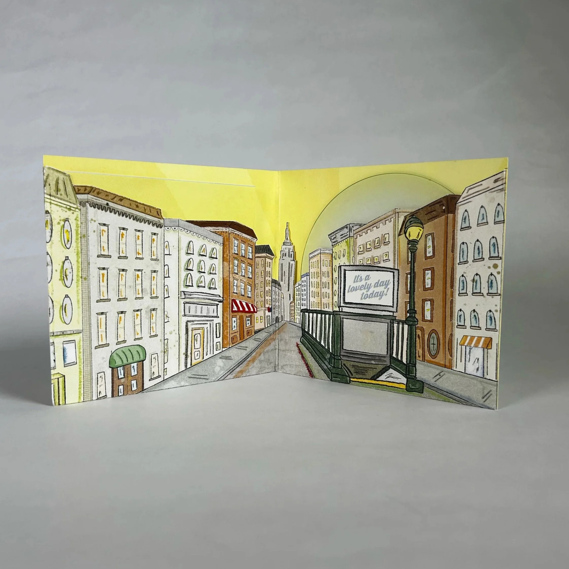 Colorful illustrated city street scene with New York‑style buildings creating the pockets that hold the CD and liner notes.