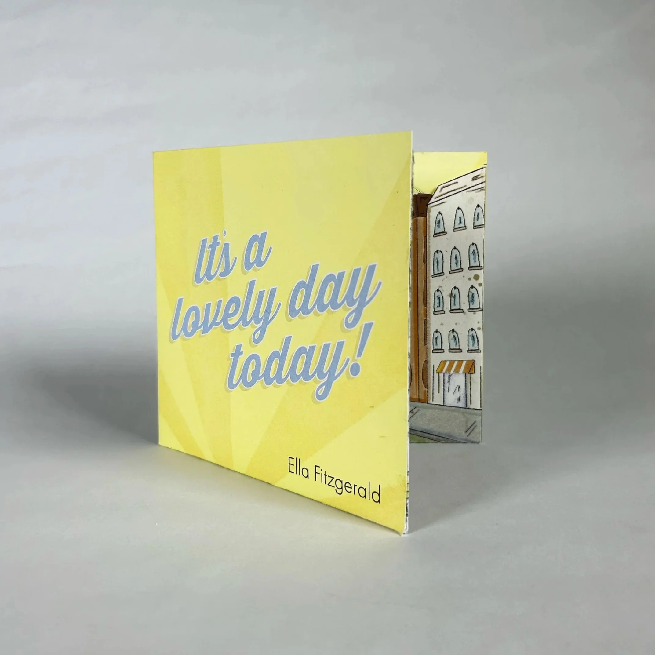 CD cover for ‘It’s a Lovely Day Today!’ featuring blue cursive lettering on a yellow background.