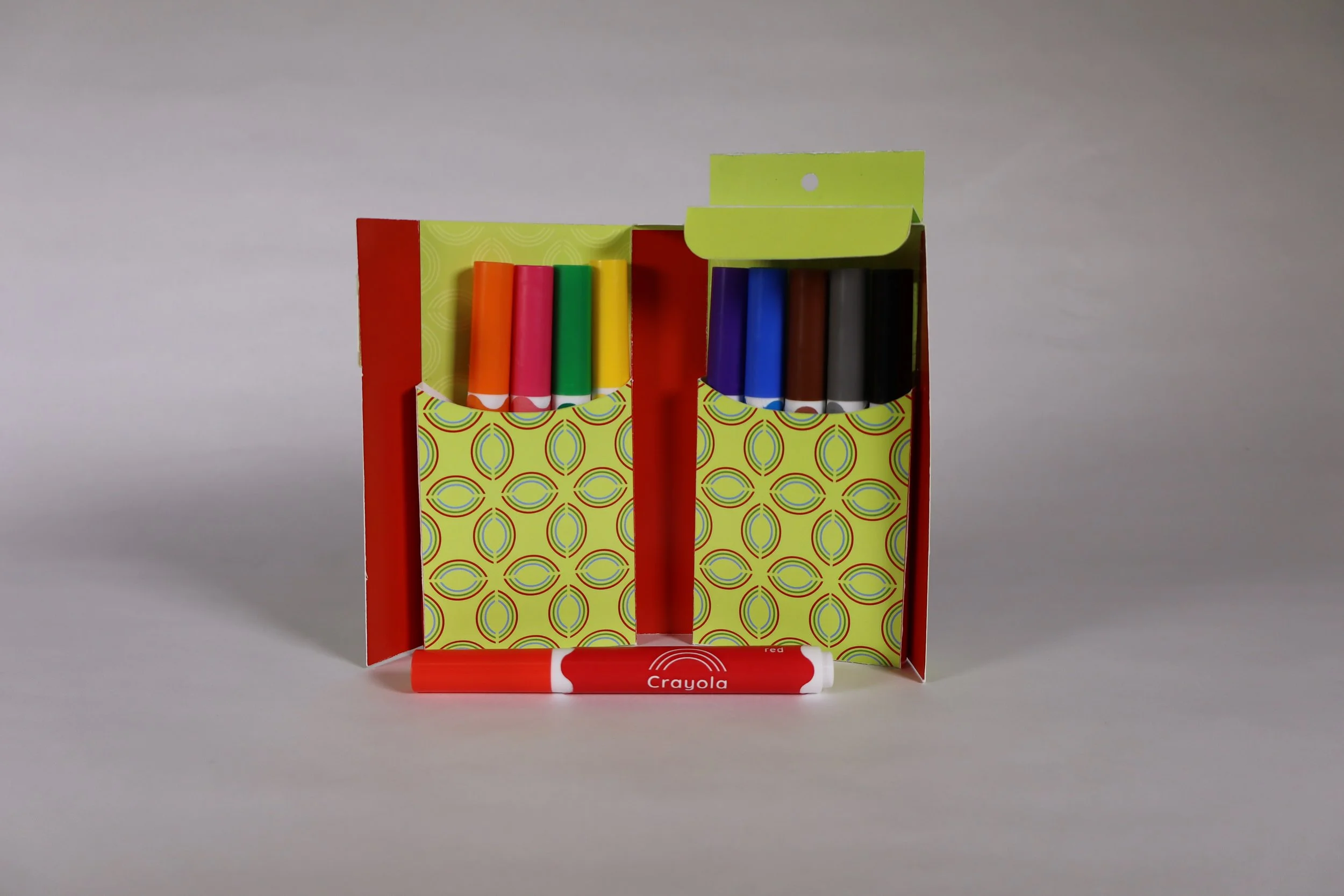 Open redesigned marker box showing two patterned pockets holding neatly arranged crayons.