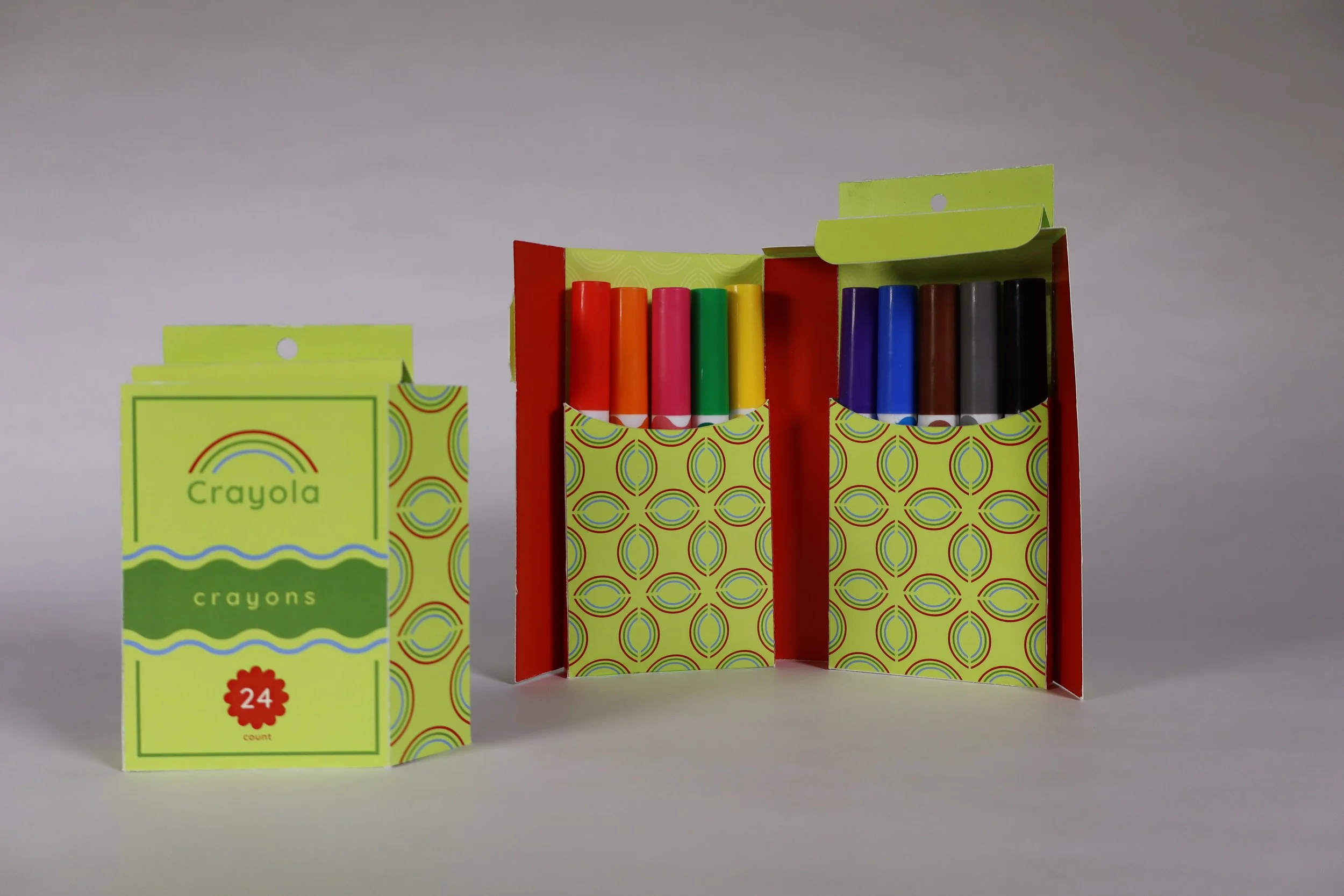 Redesigned Crayola crayon box with green background, circular patterns, and a red starburst reading 24.
