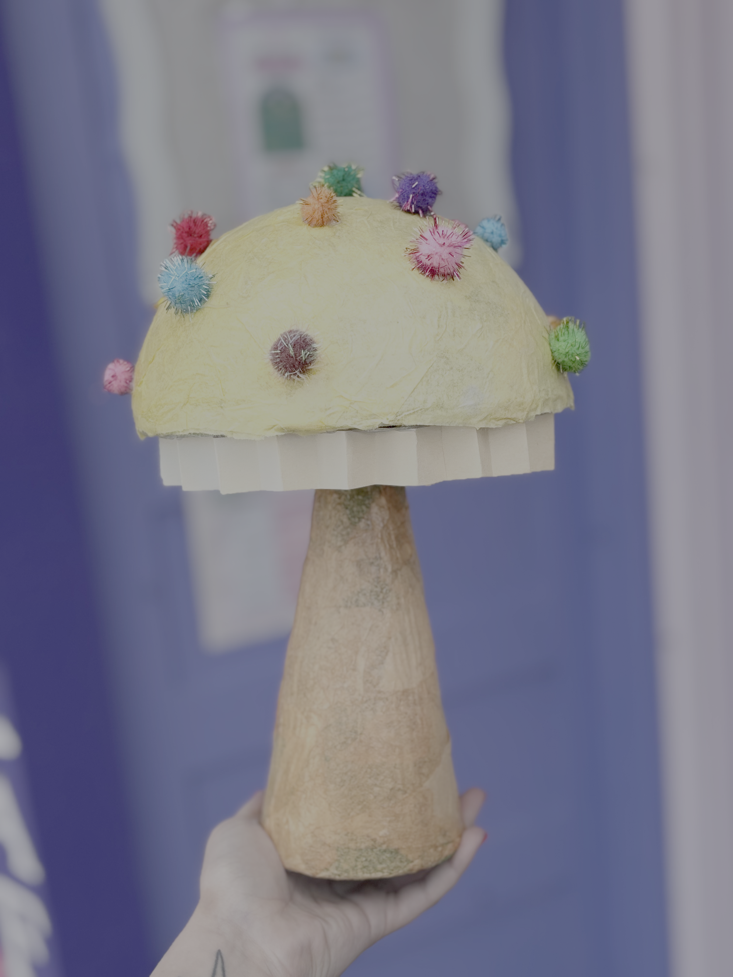 Whimsy mushroom made from foam, tissue paper, pompoms, mod podge and hot glue.