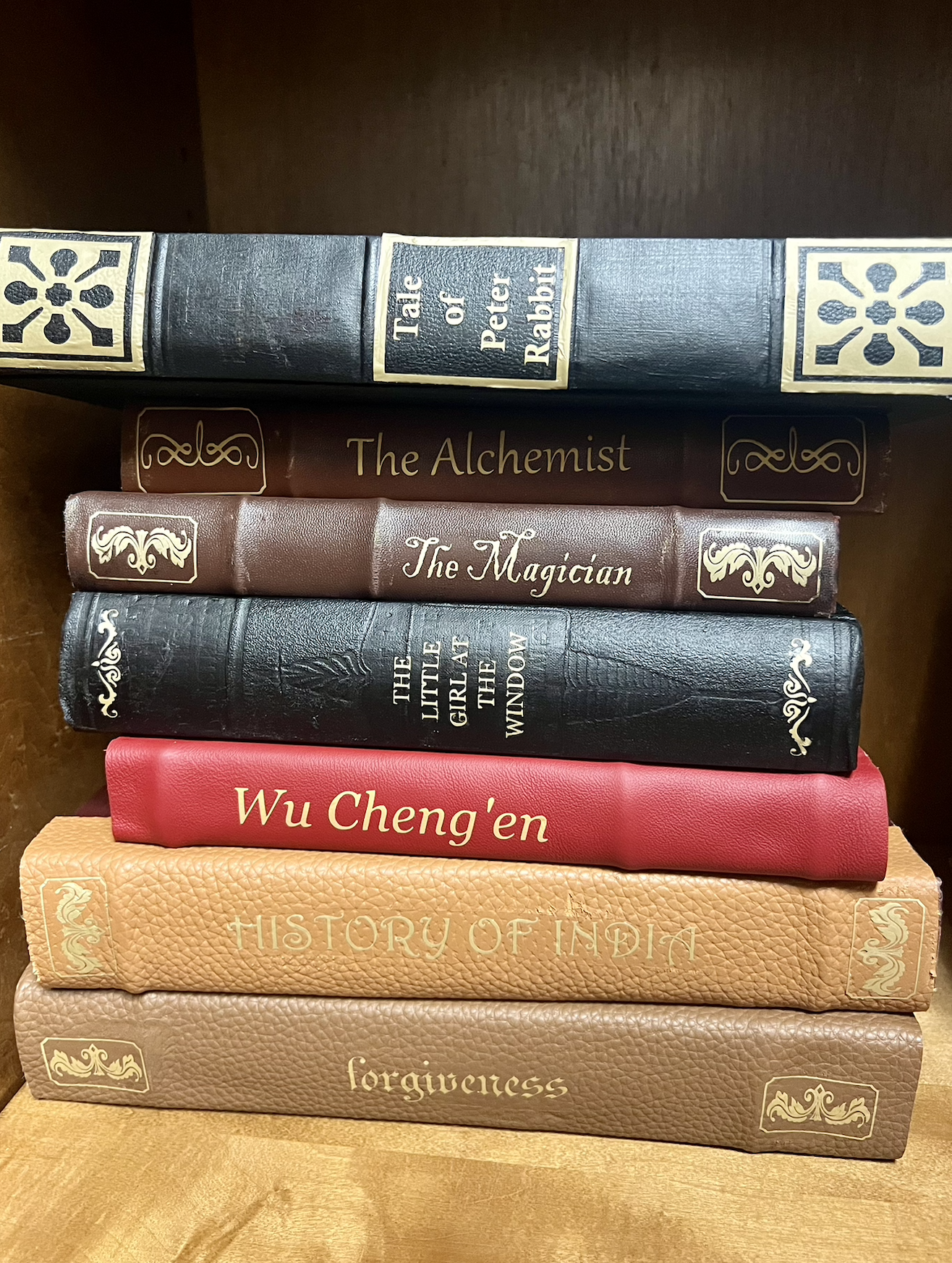 Fabricated, designed, and cut/placed vinyl on books.