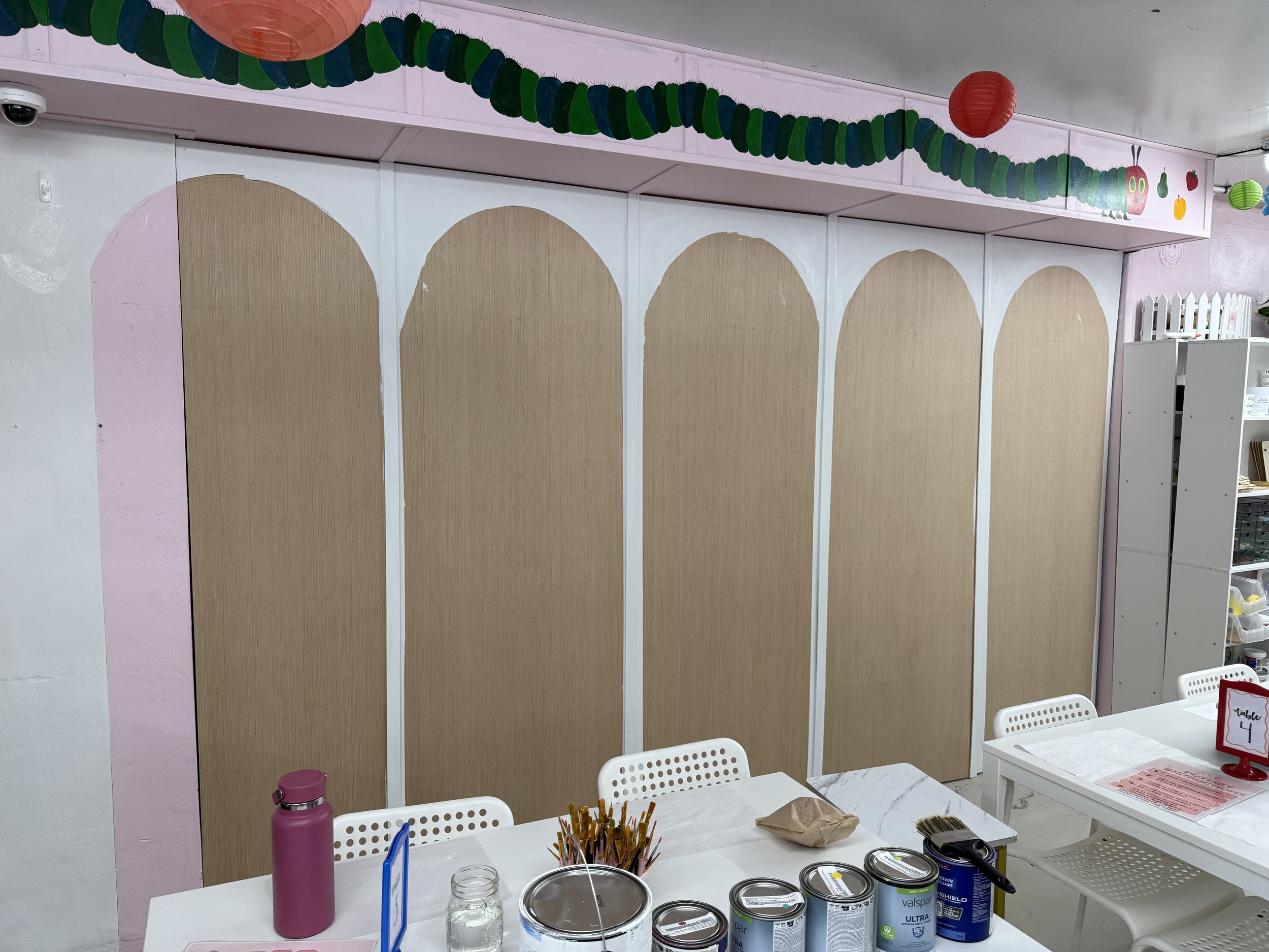 Arched dividers created for bookshelves in Carly & Cass DIY Studio.