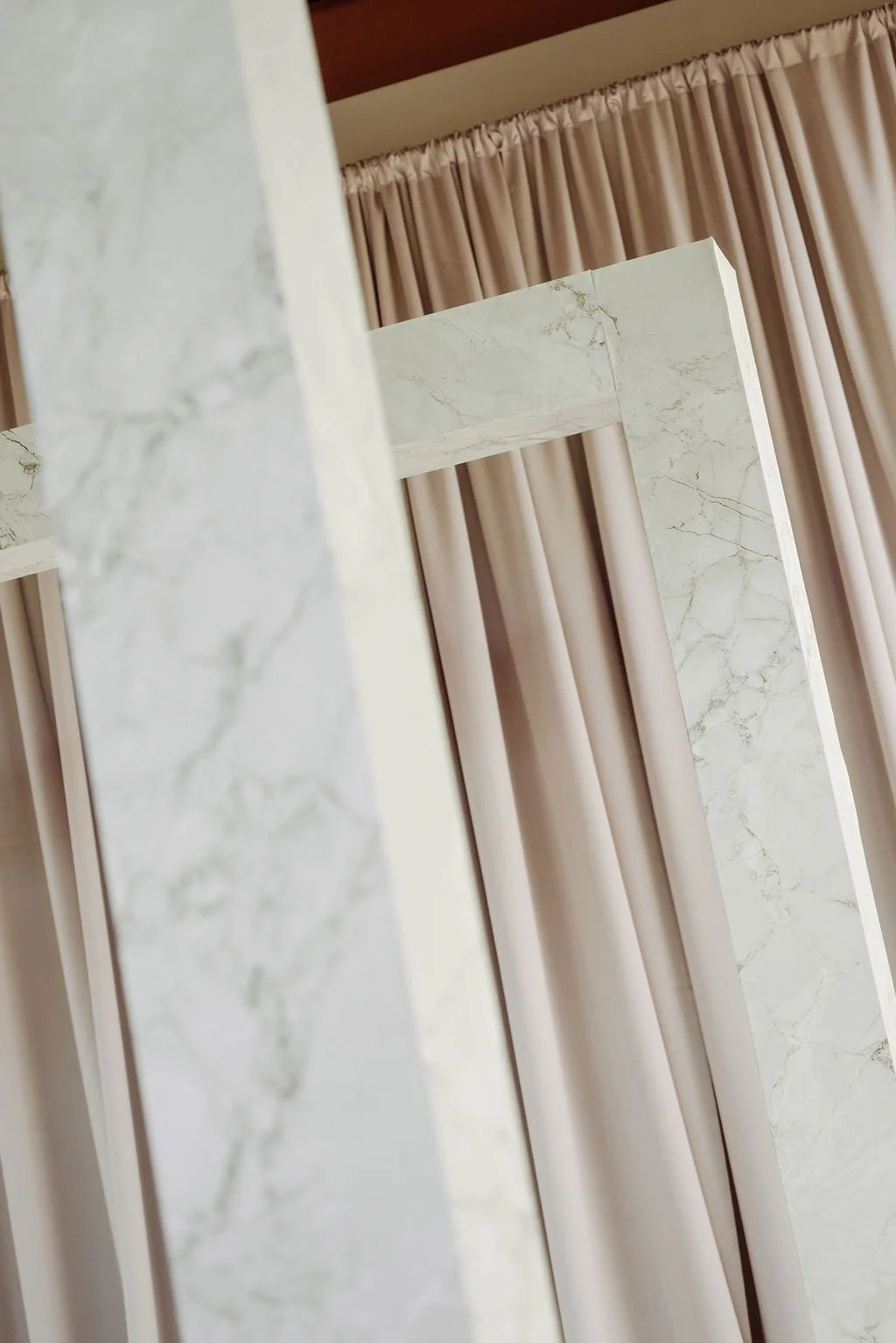 Close-up architectural detail of FRAME ceremony structure with vinyled Marble finish.
