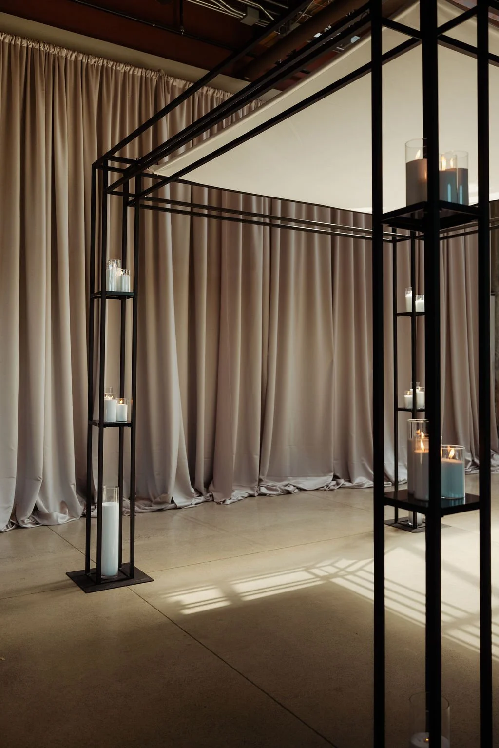 AXIS black ceremony structure with adjustable shelving for candles and floral styling