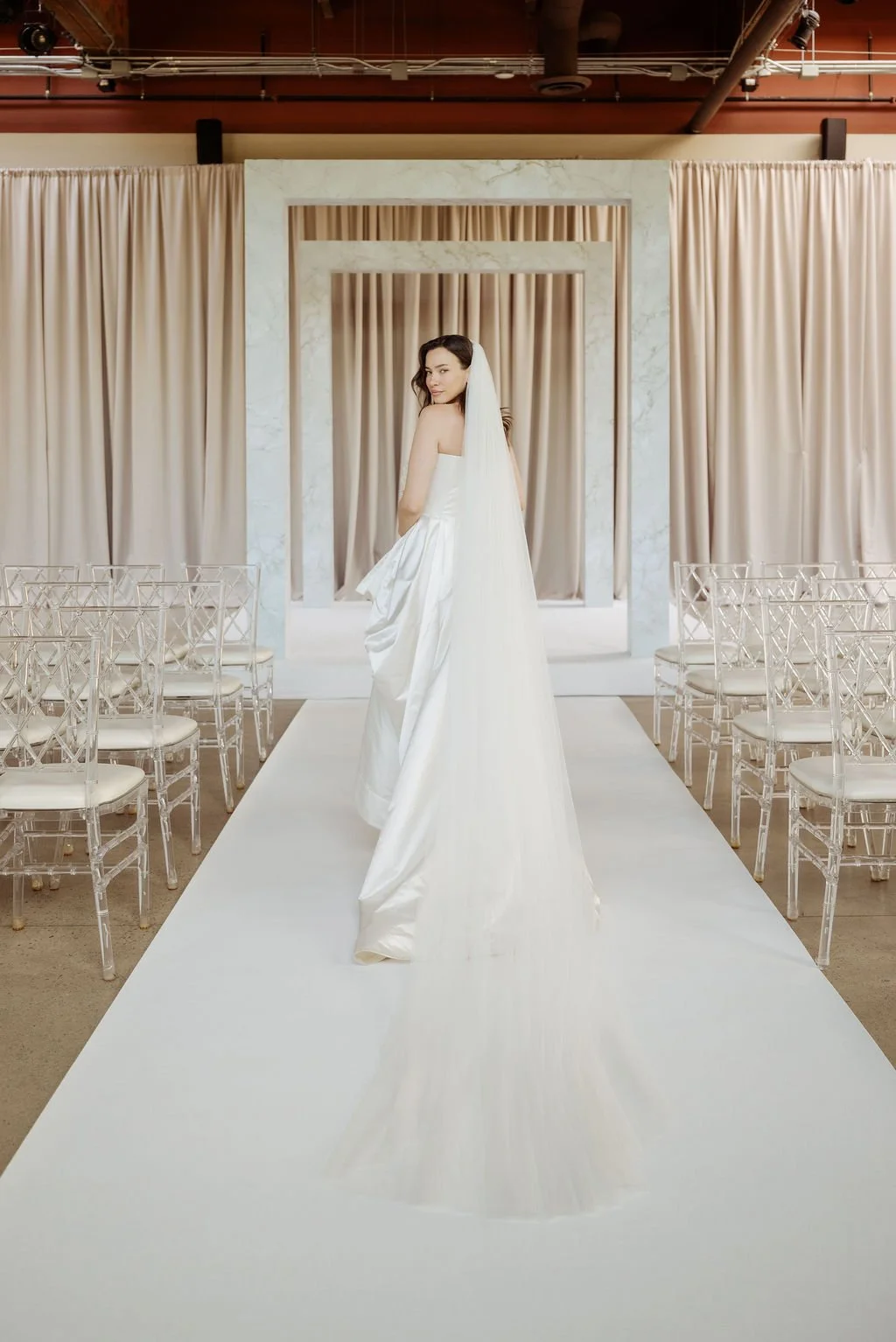 Bride approaching FRAME modern chuppah with integrated stage