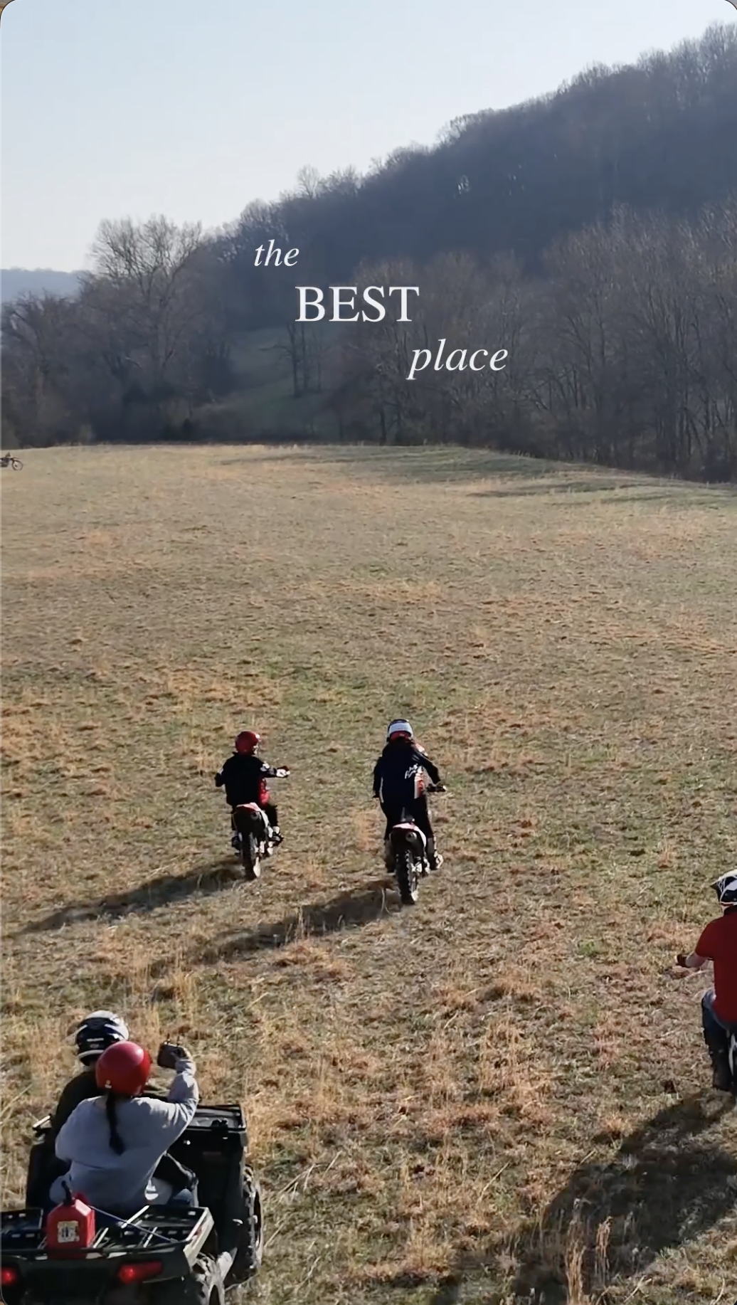 Group of children riding small dirt bikes on a grassy field with hills and trees in the background, and the text 'the BEST place' overlaid.