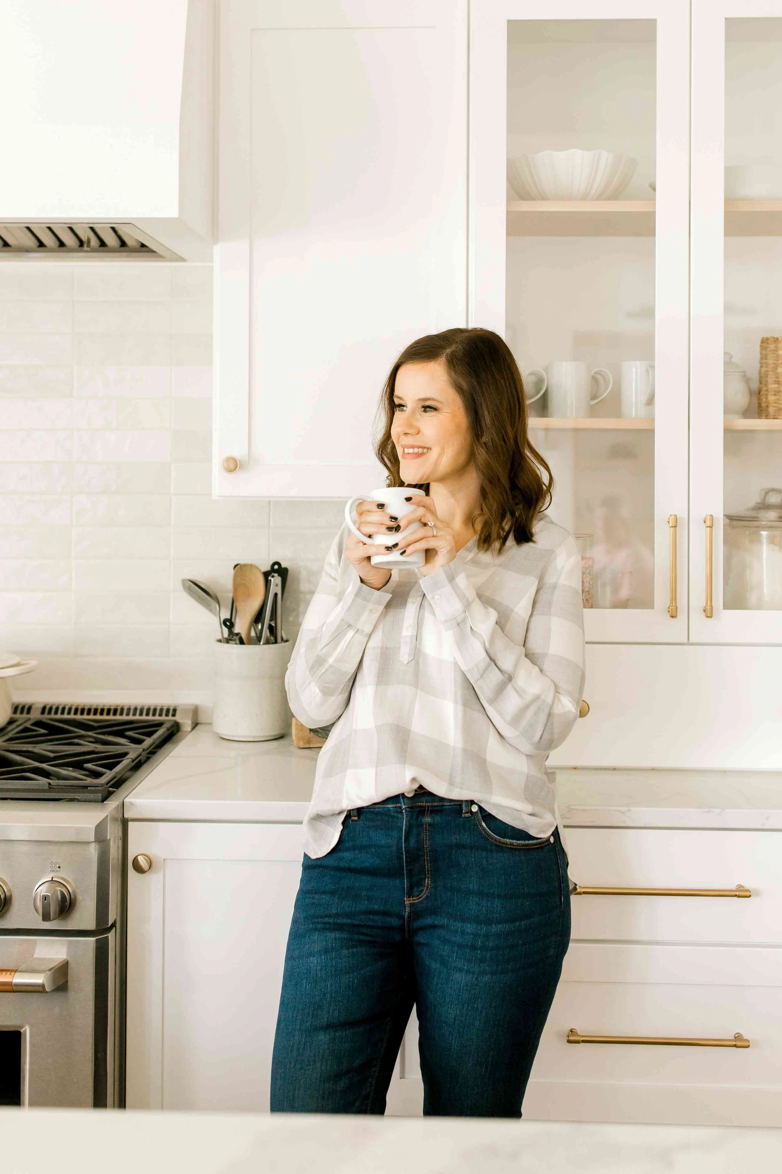 Heather, a Holland, Michigan real estate agent, enjoying coffee in a modern kitchen.