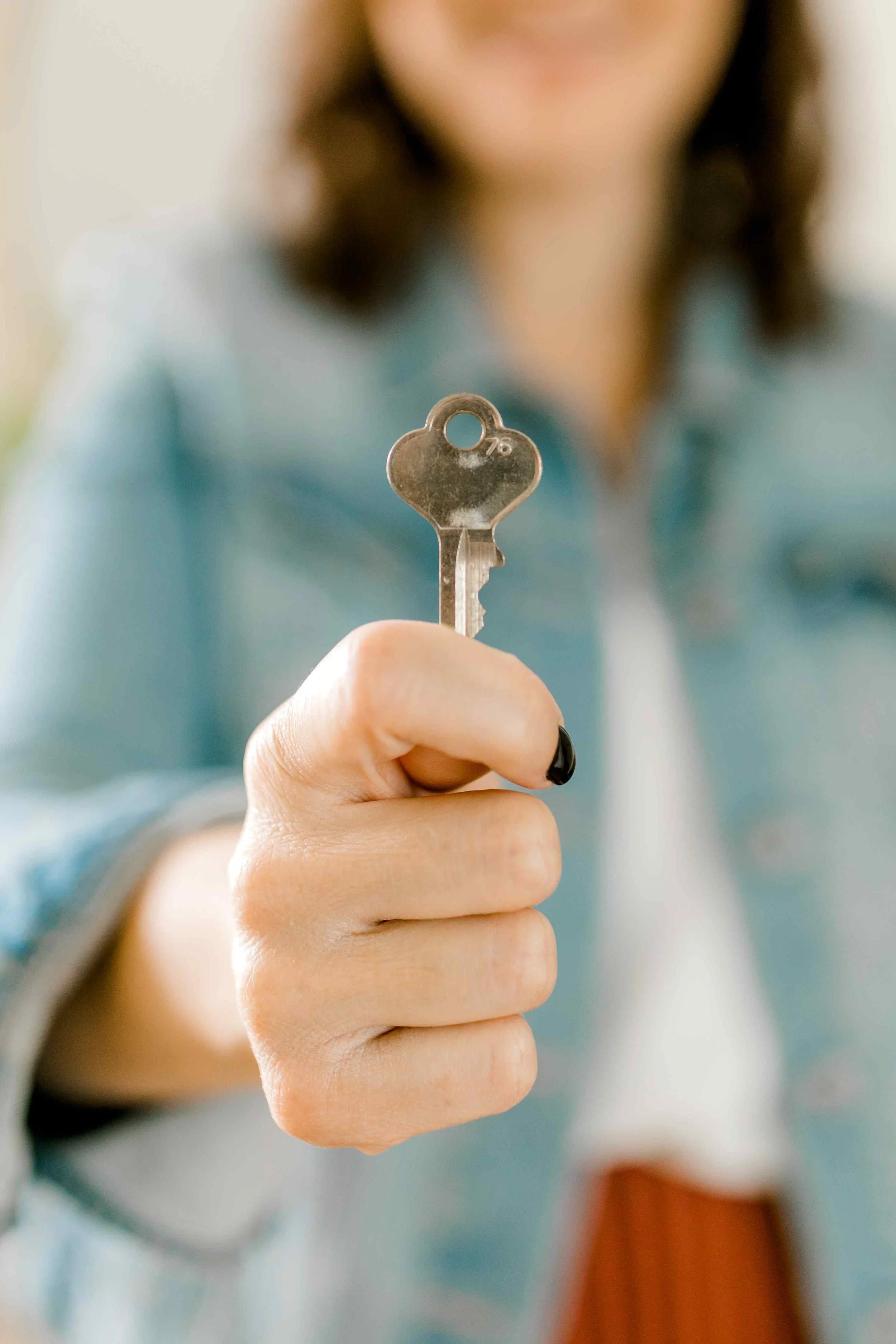 Heather, a Holland, Michigan realtor, handing over keys to a new homeowner.