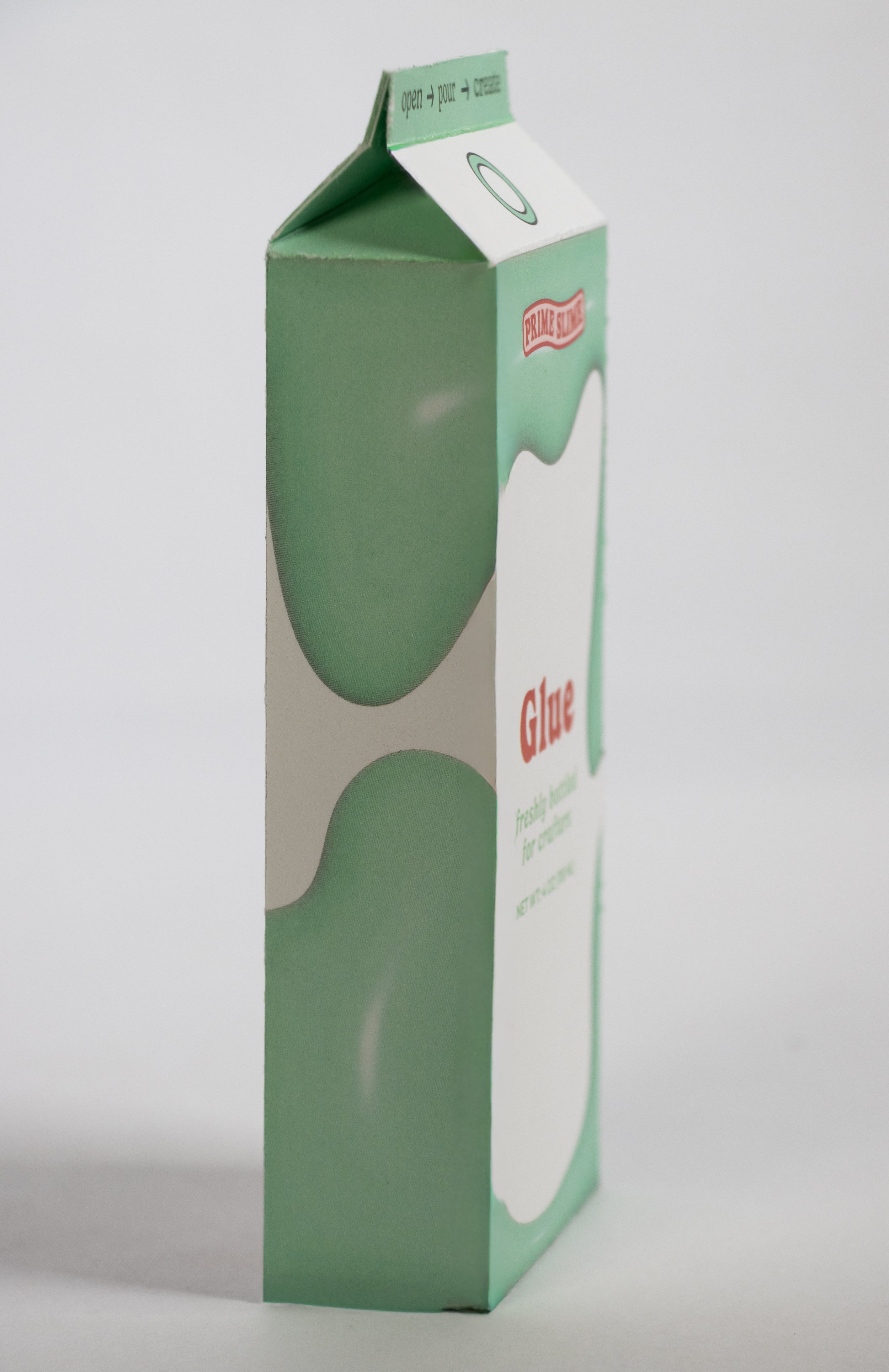 Carton of green primer slime glue for crafts, standing upright with the top flap slightly open.
