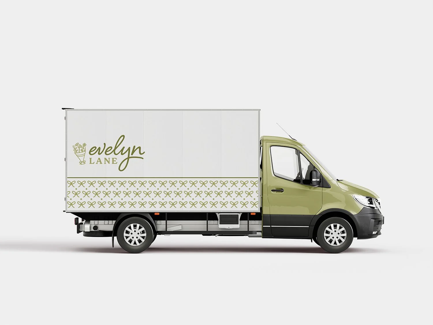 A delivery truck with a beige cab and white cargo area, displaying the words "evelyn LANE" and a floral logo on the side.