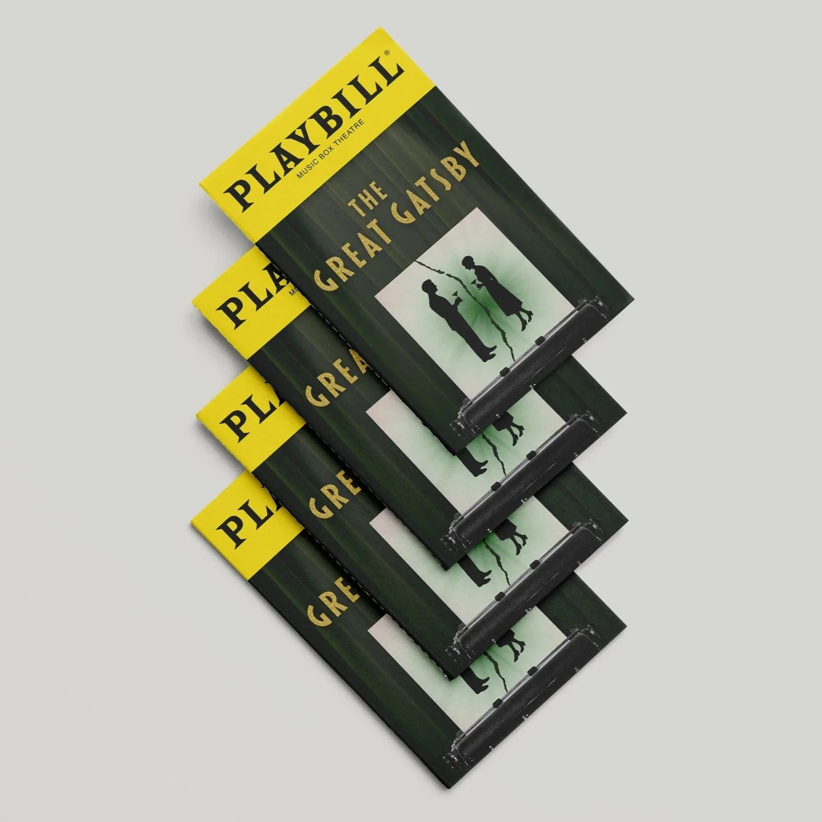 Four copies of a Playbill for 'The Great Gatsby' musical with a green curtain backdrop and silhouette graphic on the cover, overlapping each other on a light gray surface.