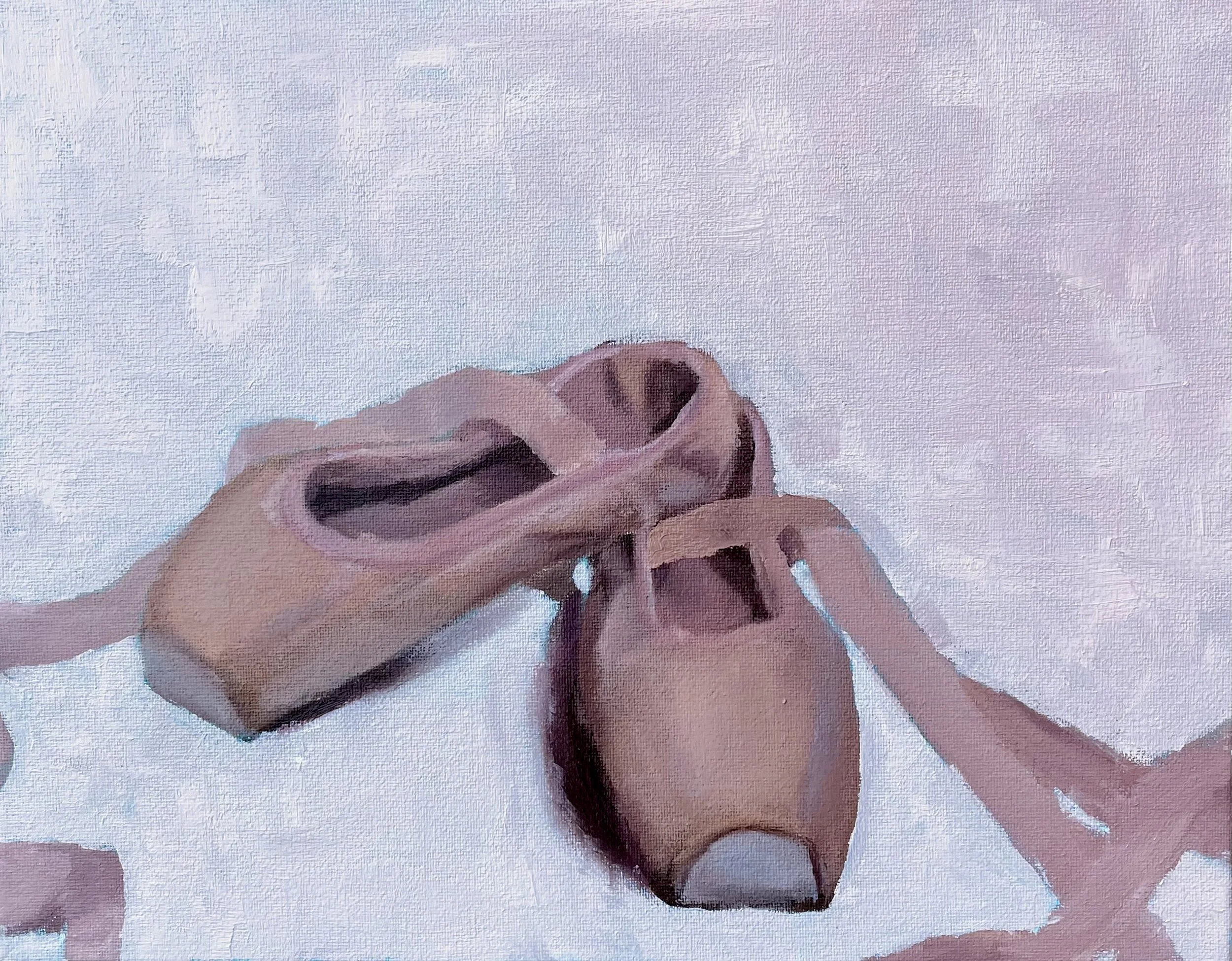 Close-up of a person's hand tying shoelaces on a brown shoe against a light-colored background.